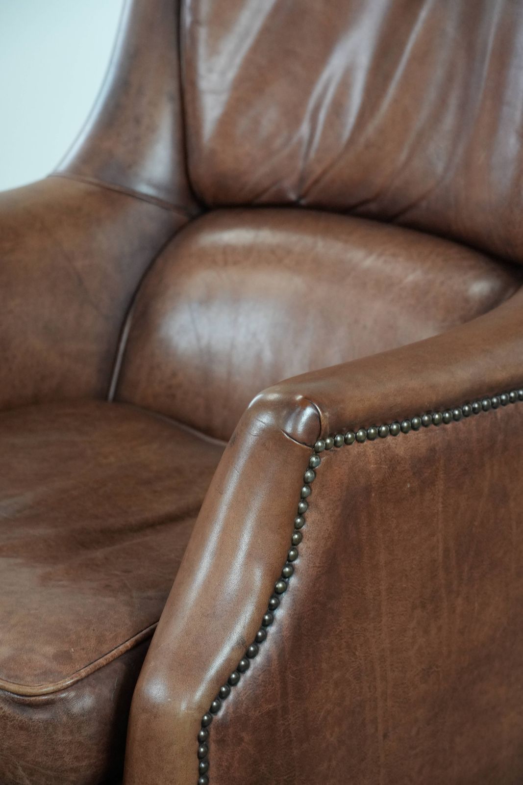 photo for sale Very Comfortable And Luxurious Cognac Brown Cowhide Armchair With A Decorative Stud Finish