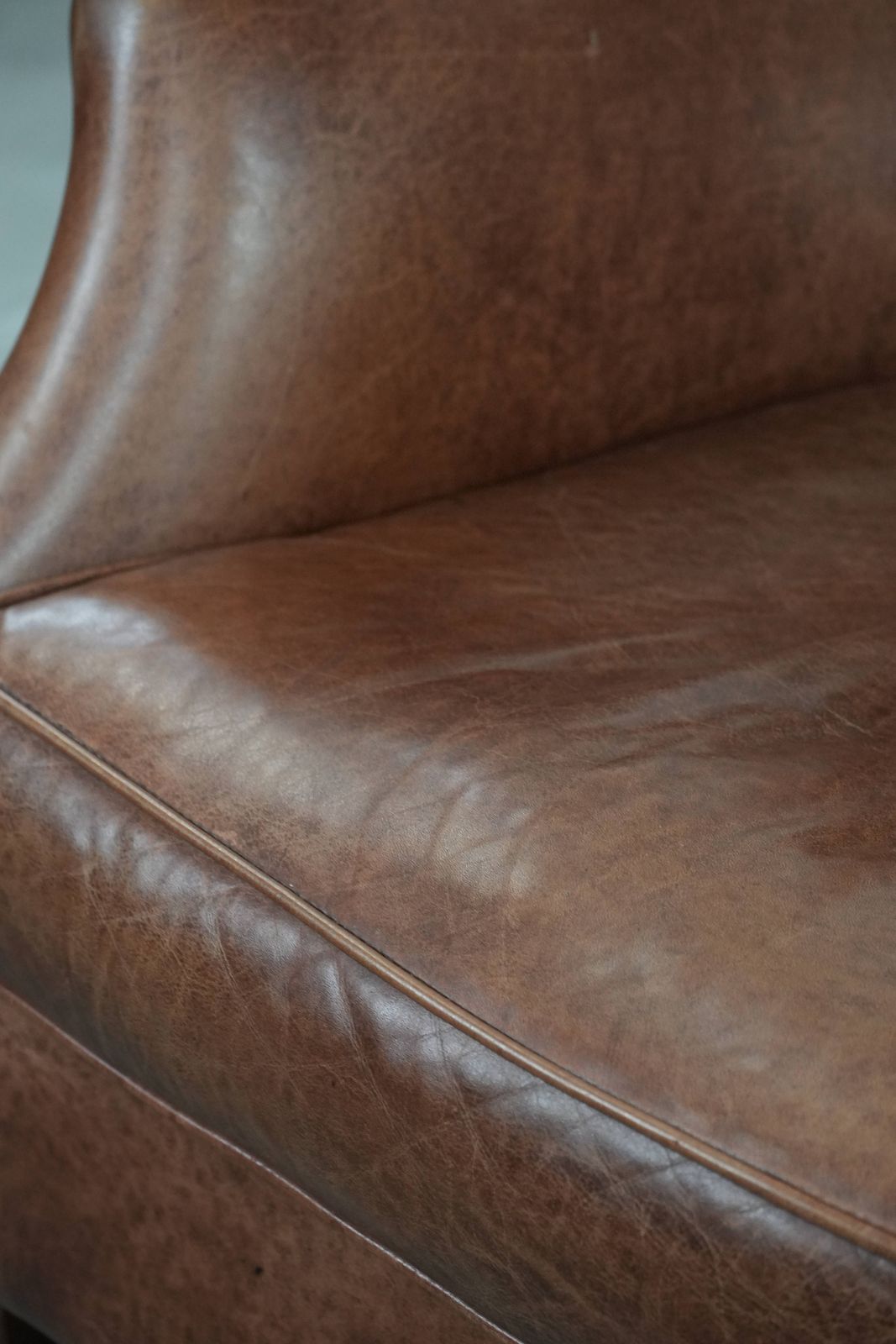 photo vinterior Very Comfortable And Luxurious Cognac Brown Cowhide Armchair With A Decorative Stud Finish