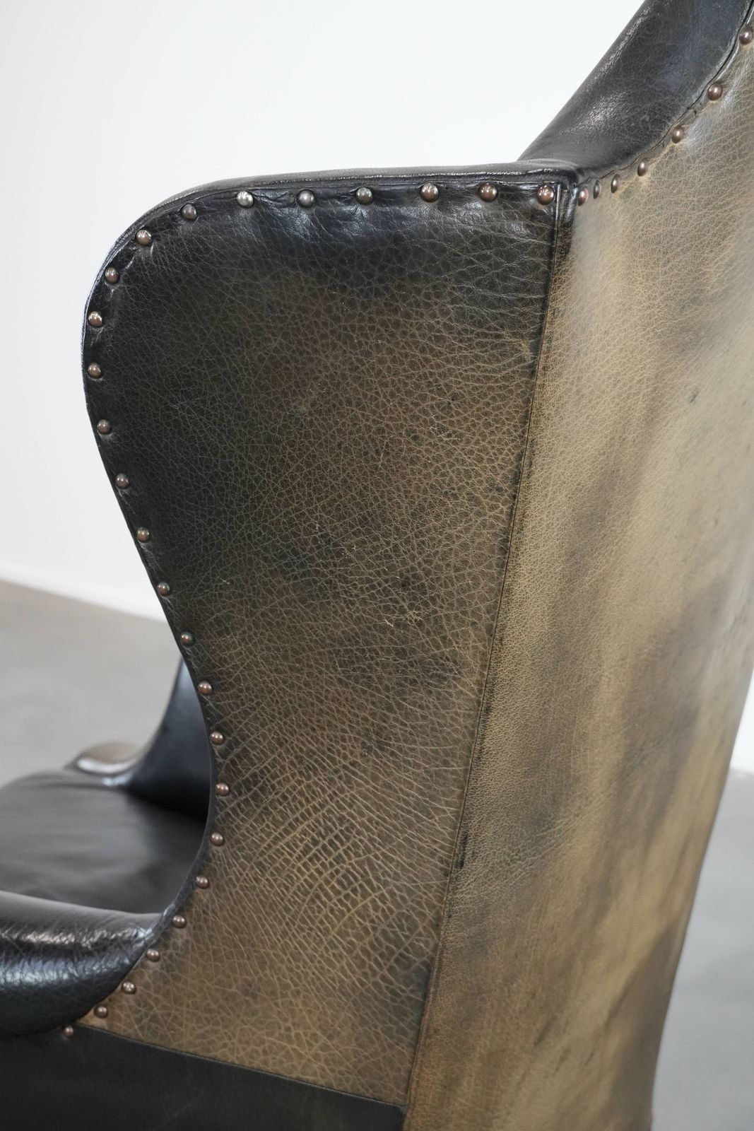 1329.0 Large Antique Black English Cowhide Wing Chair From The Late 19th Century With A Luxurious Appearance photo