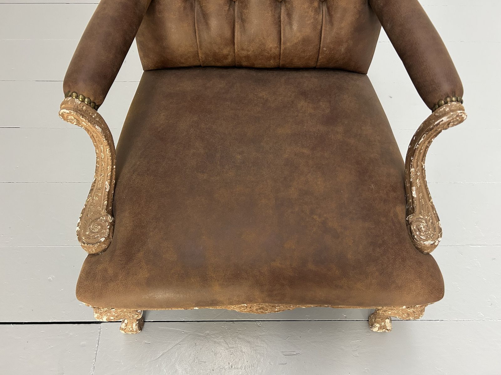 photo furniture Andrew Martin Buttoned Back Armchair And Stool In Antiqued Brown Leather