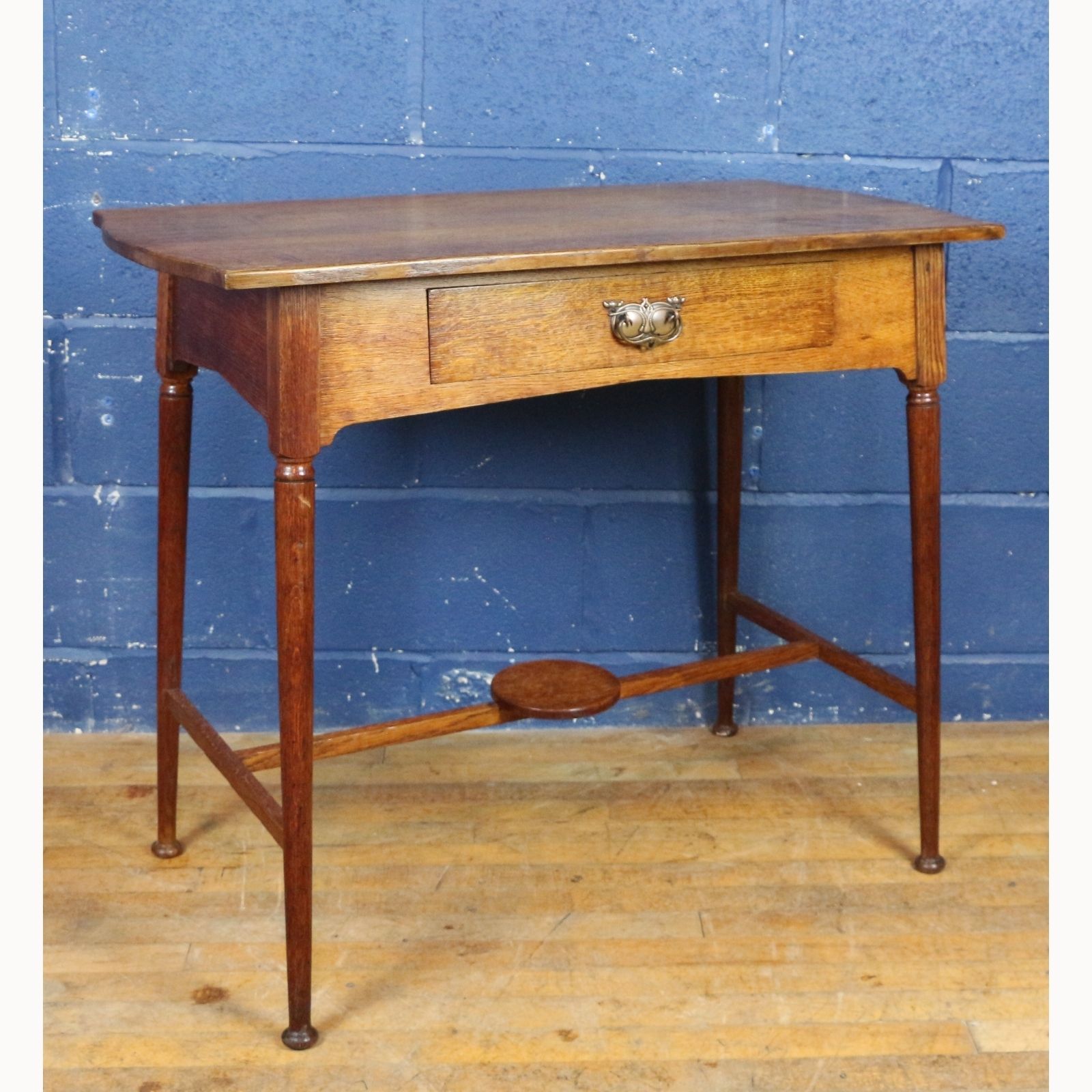 An Art Nouveau Oak Single Drawer Side Table Raised On Turned Angled Supports