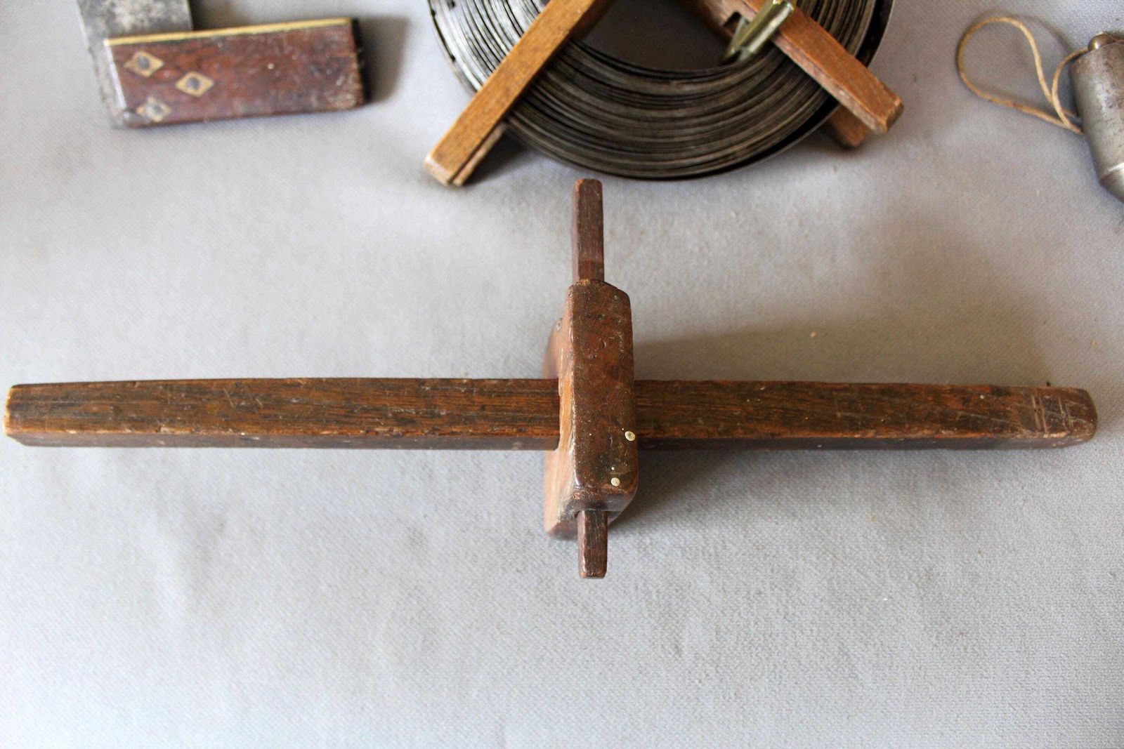 Home Decor Set Of Four Antique Wood Tools, Surveyor Coiled Steel Tape Measure With Brass, A Scribe Marking Gauge, Square With Inlay, Metal Plumb Bob, photo