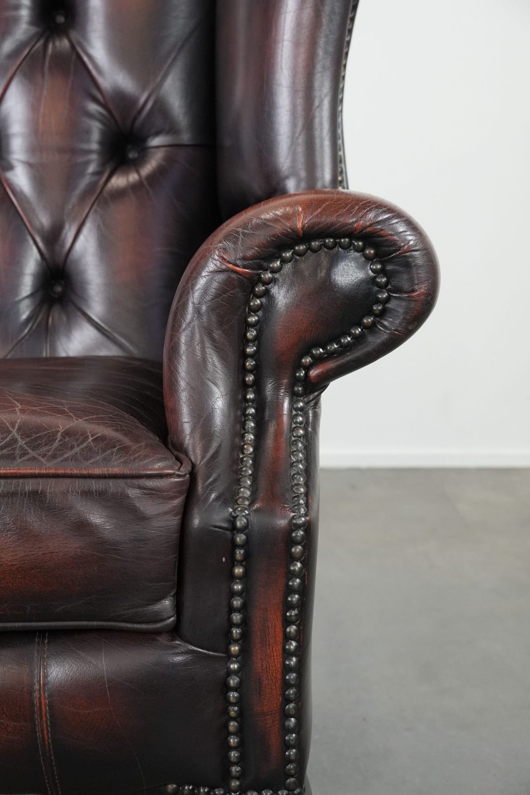 photo furniture Beautiful, Luxurious, And Comfortable Brown Cowhide Chesterfield Wing Armchair In A Classic English Style.