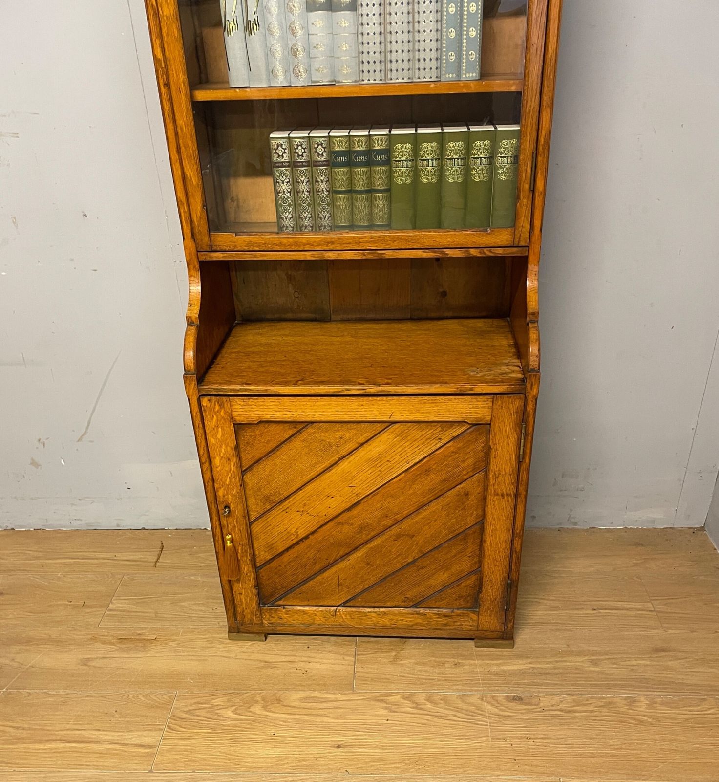 795.0 Arts And Crafts Golden Oak Slim Bookcase Over Cupboard photo