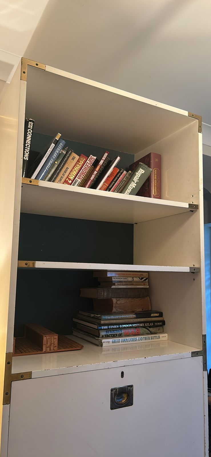 A Mid Century Modular White Shelving Unit In A Campaign Style With Solid Brass Features photo vinterior