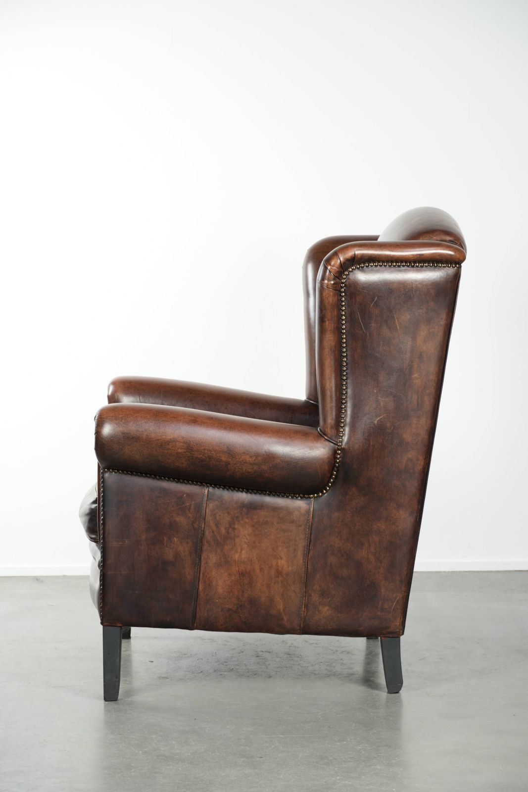 Beautiful Large And Comfortable Sheepskin Wing Armchair With Lovely Deep And Warm Colors And A Finish With Decorative Nails. photo 1265.0