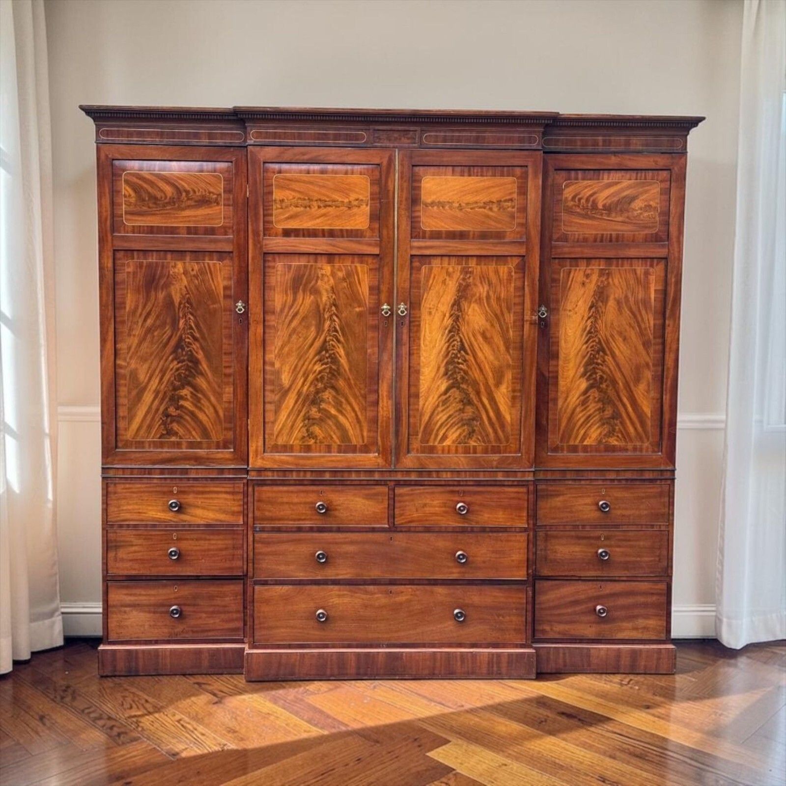 A Large Regency Figured Mahogany Breakfront Wardrobe With Brass Inlaid Decoratio