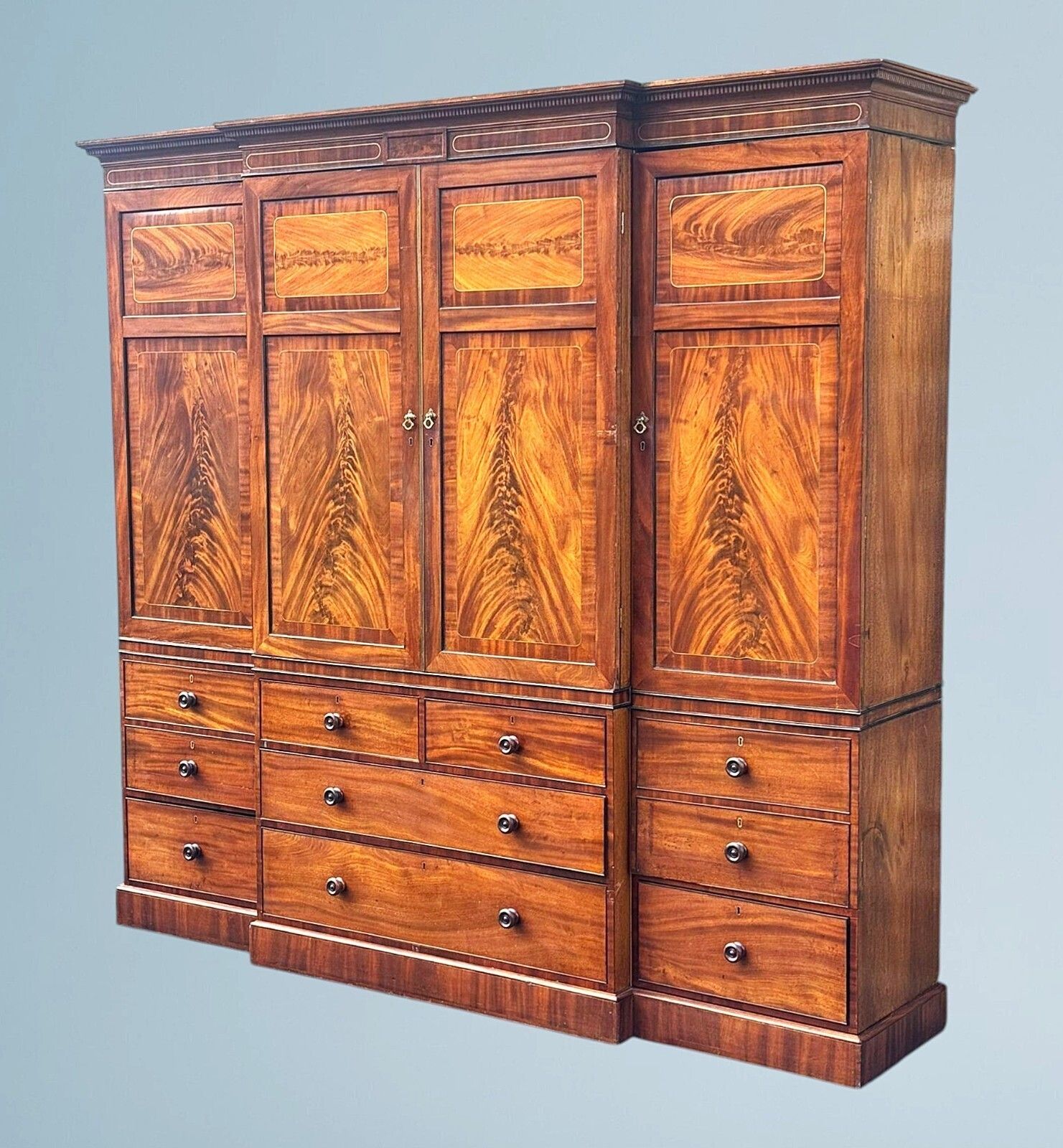 A Large Regency Figured Mahogany Breakfront Wardrobe With Brass Inlaid Decoratio photo furniture
