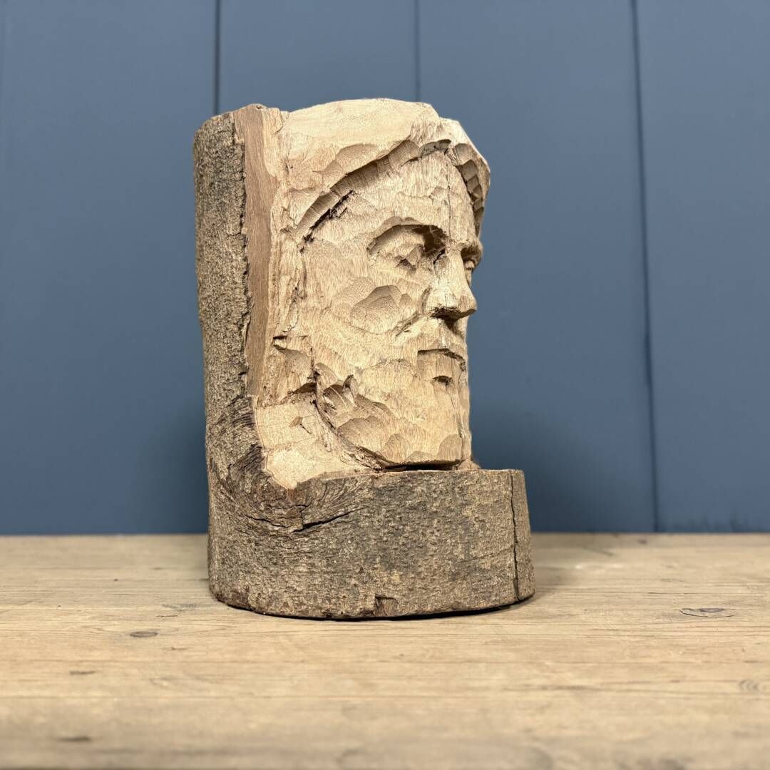 Head Of A Bearded Man Carved From A Wooden Trunk photo furniture