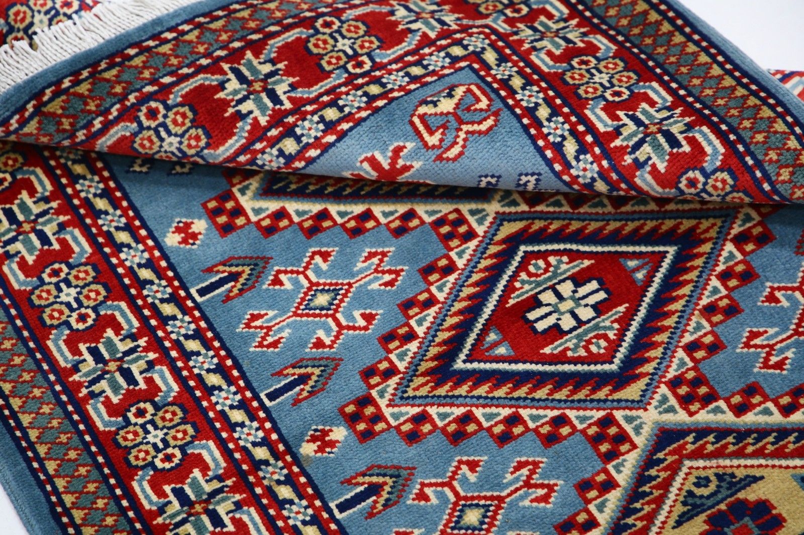 Tapis d'accent en laine fait main, bleu, rouge et ivoire, motif médaillon géométrique, 60 x 90 cm photo vinterior