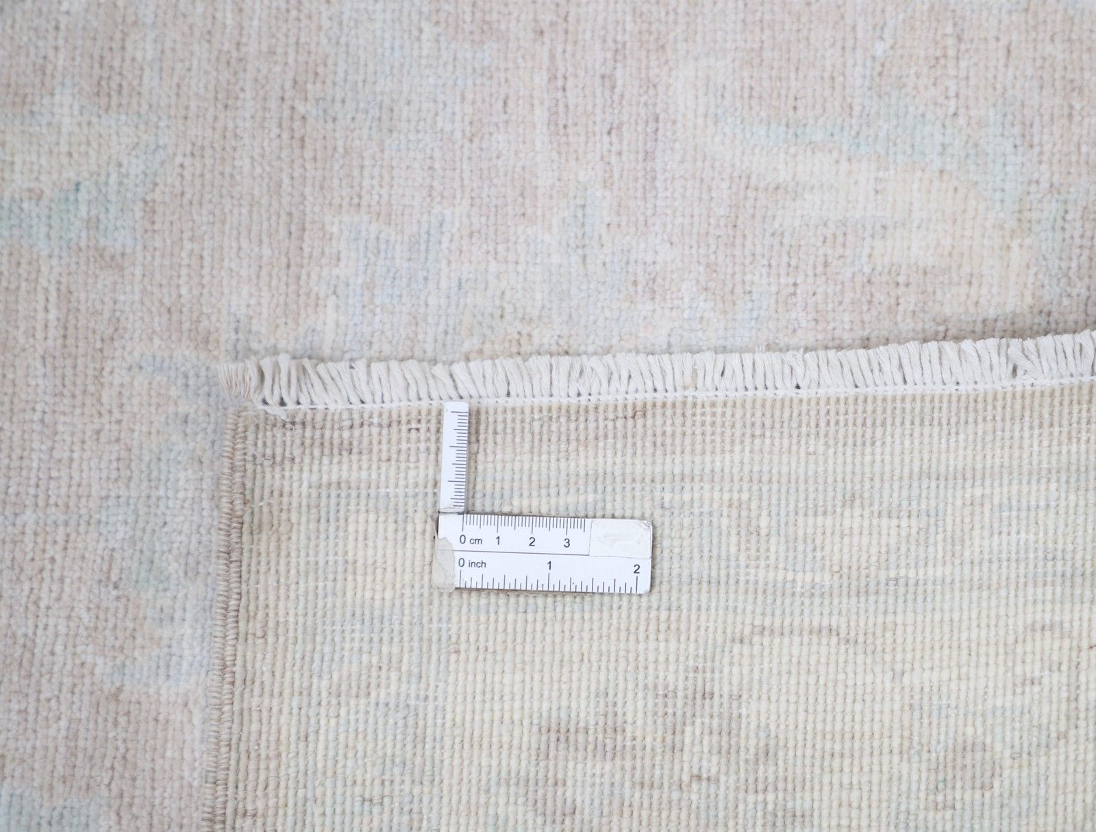 Handgeknoopt Turks vloerkleed 92 x 153 cm in zachte tinten. 100% wol. Beige klein vloerkleed photo 752.0