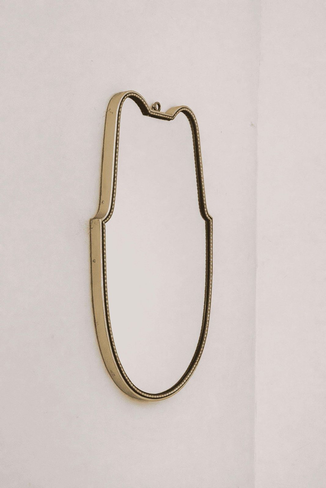 Italian Mid Century Modern Brass Shield Mirror In The Style Of Gio Ponti, 1960s photo for sale