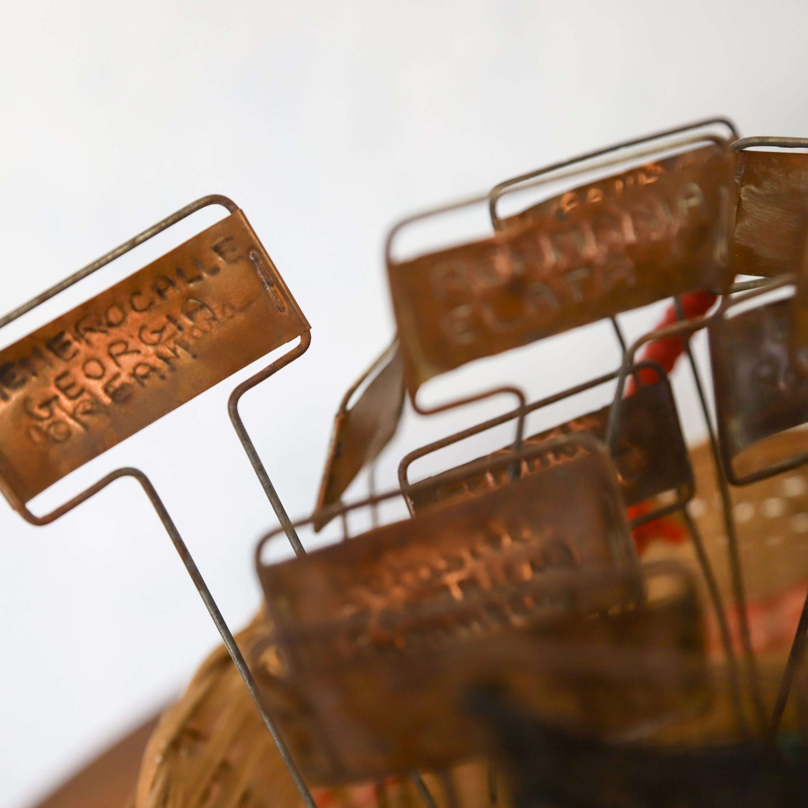 photo furniture Large Collection Of Vintage English Estate Gardener’s Copper Plant Labels In 1950s Basket