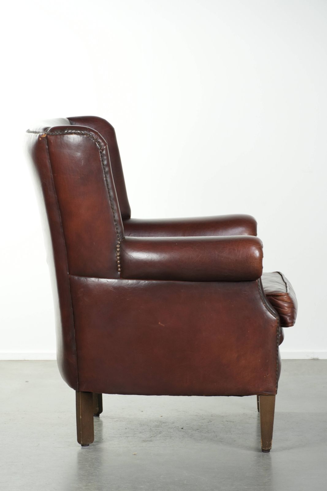 Lovely Vintage Sheepskin Armchair With A High Back In A Beautiful, Subtle Size, Finished With Decorative Nails. photo for sale