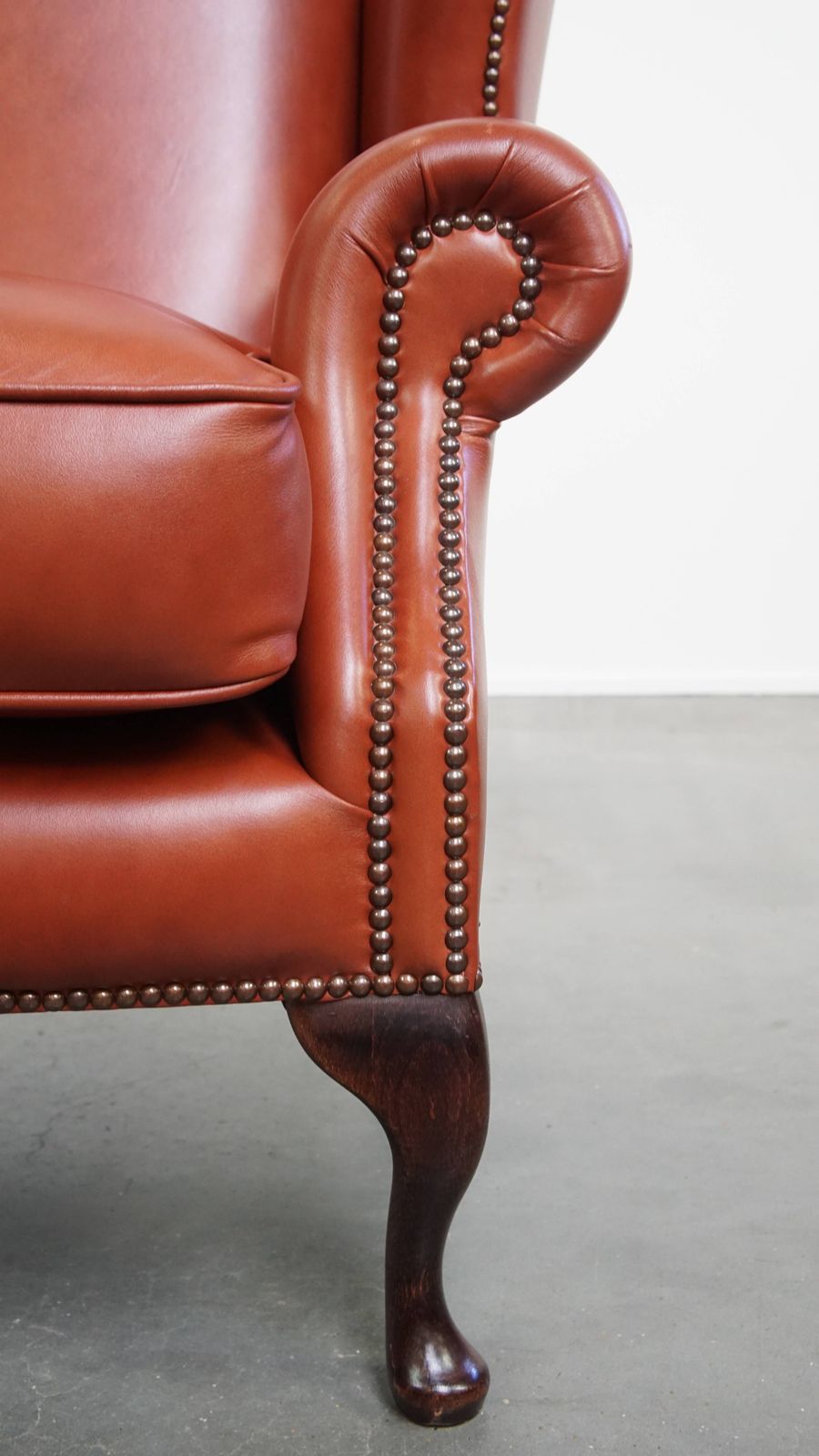 photo furniture Elegant And Comfortable Smooth English Cowhide Chesterfield Wing Armchair With Graceful Legs
