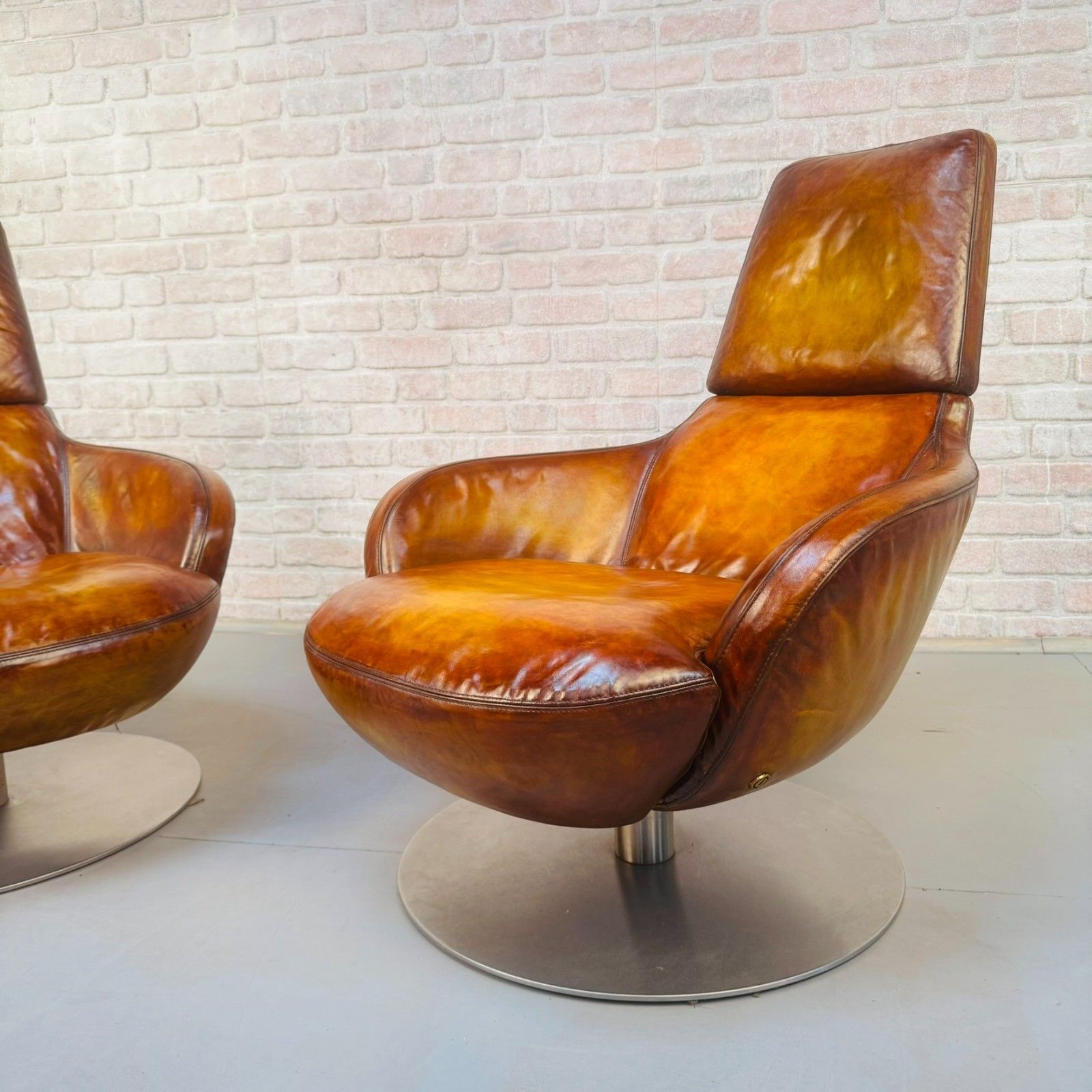 photo furniture Pair Of Vintage Italian Swivel Tan Leather Chairs