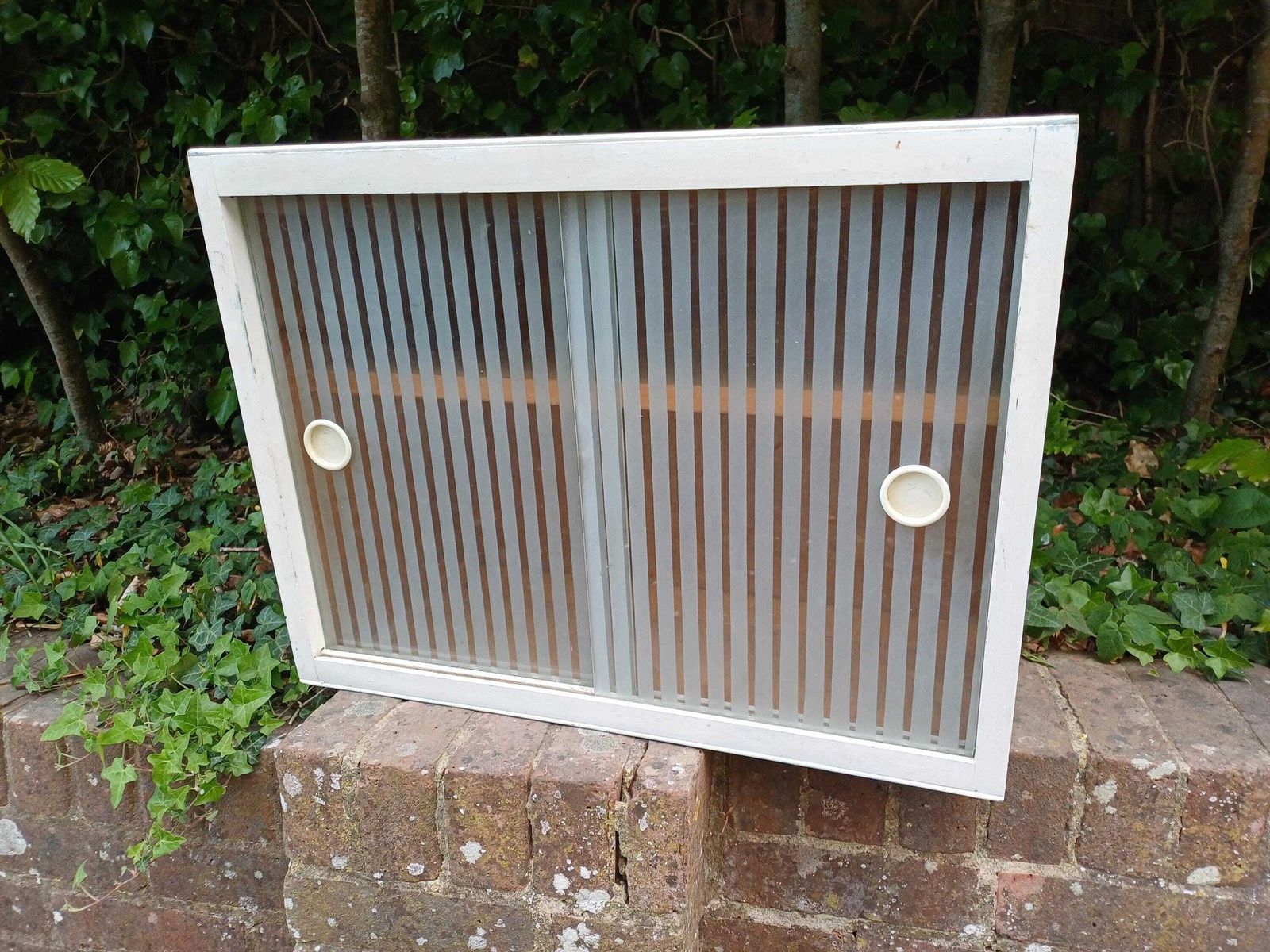 295.0 1950s Painted Kitchen Bathroom Wall Cupboard With Sliding Ribbed Glass Doors Mid Century Utility Storage Cabinet photo