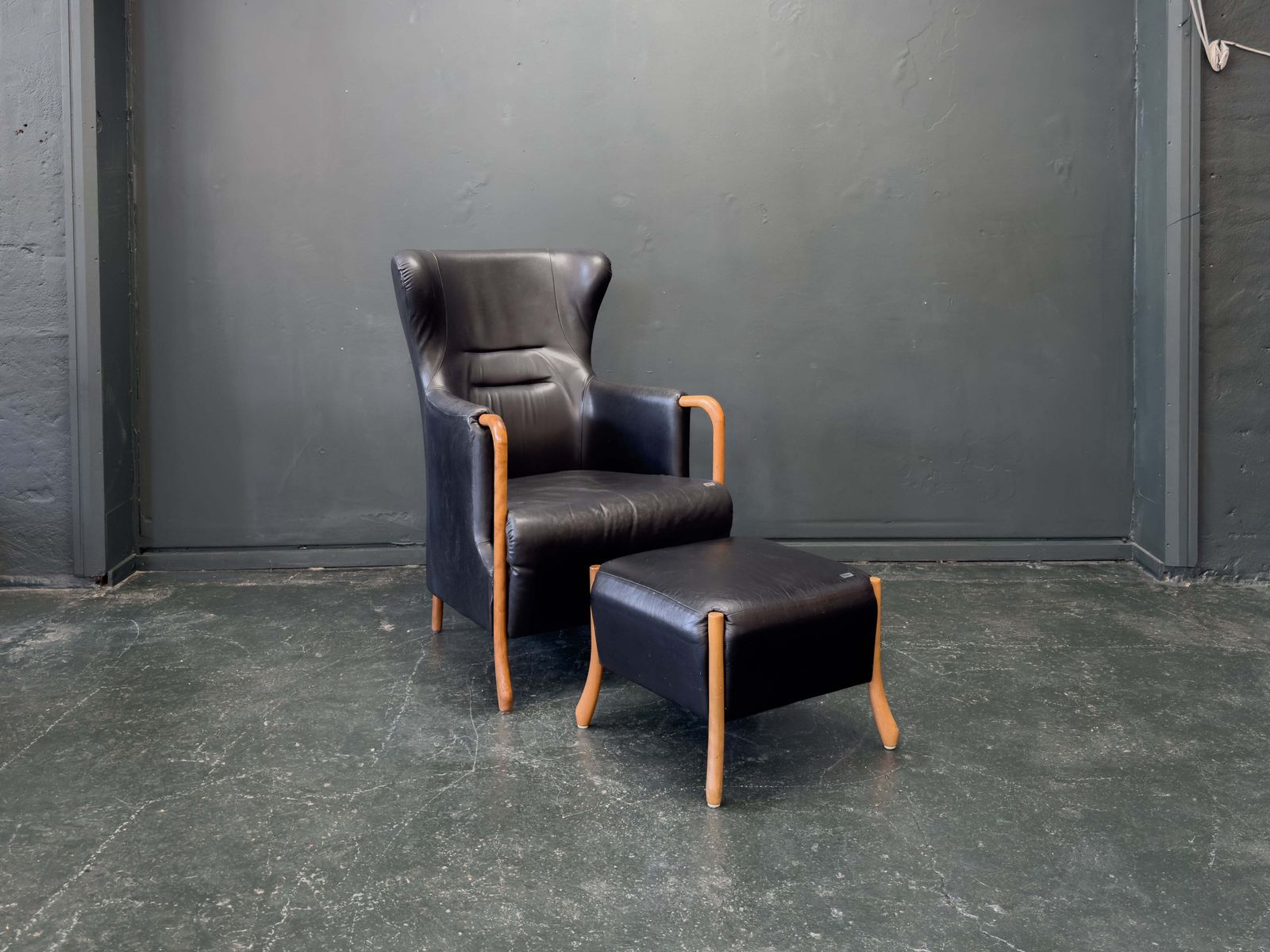 'Claudia' Black Leather And Beech Highback Armchair With Footstool By Stouby