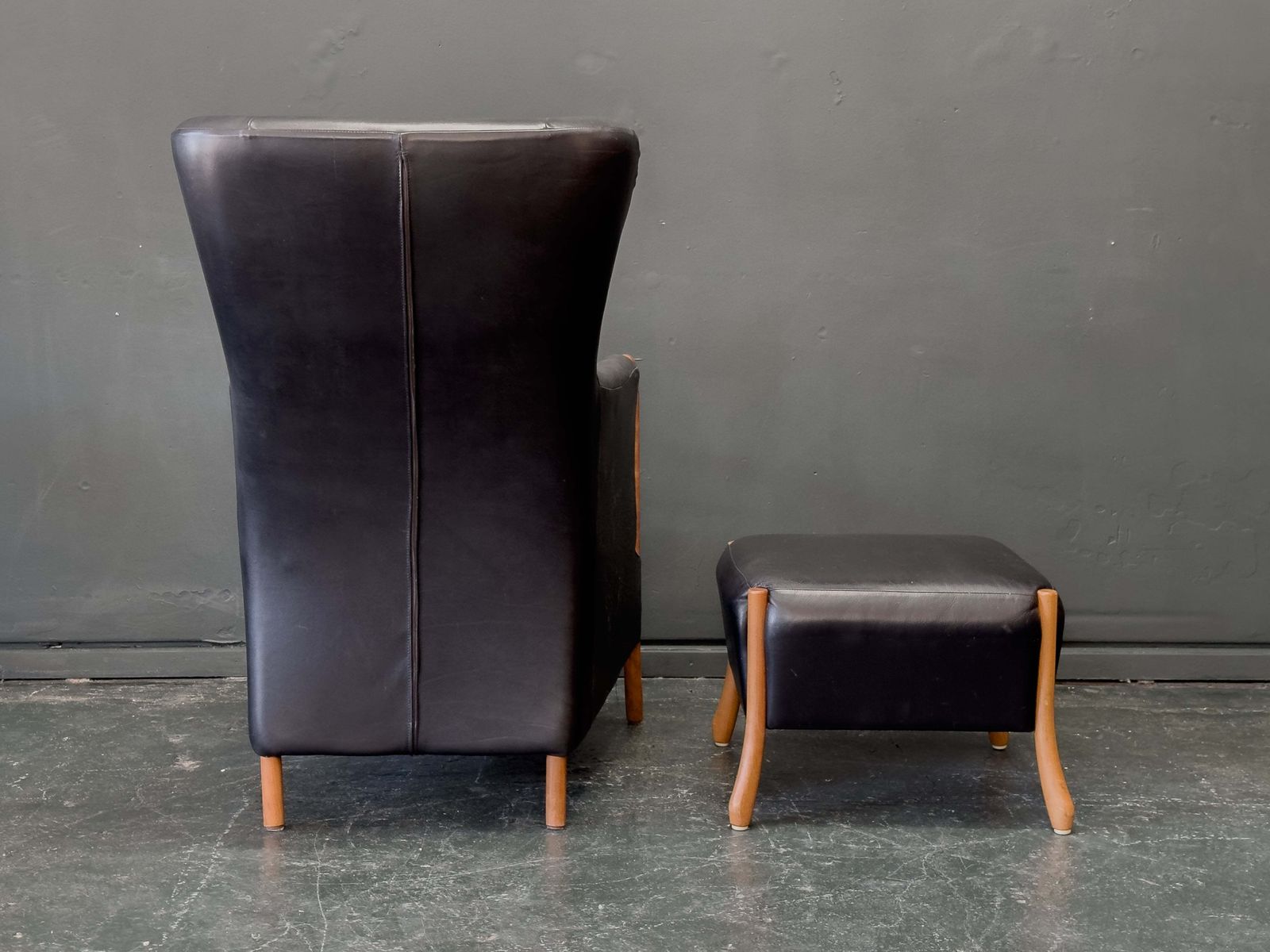 photo furniture 'Claudia' Black Leather And Beech Highback Armchair With Footstool By Stouby
