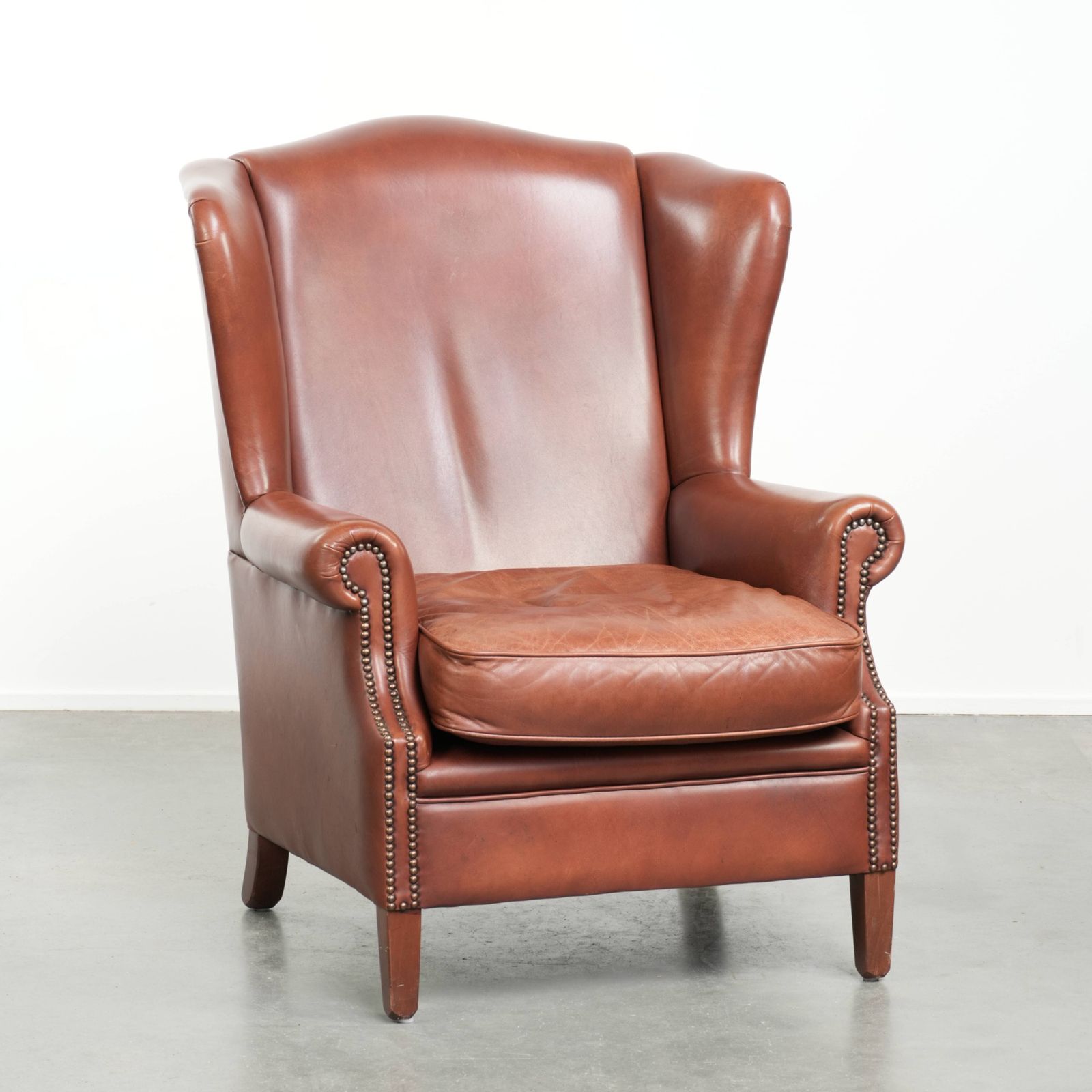 Comfortable Cognac Colored Cowhide Leather Wing Armchair In English Style With A Warm Appearance