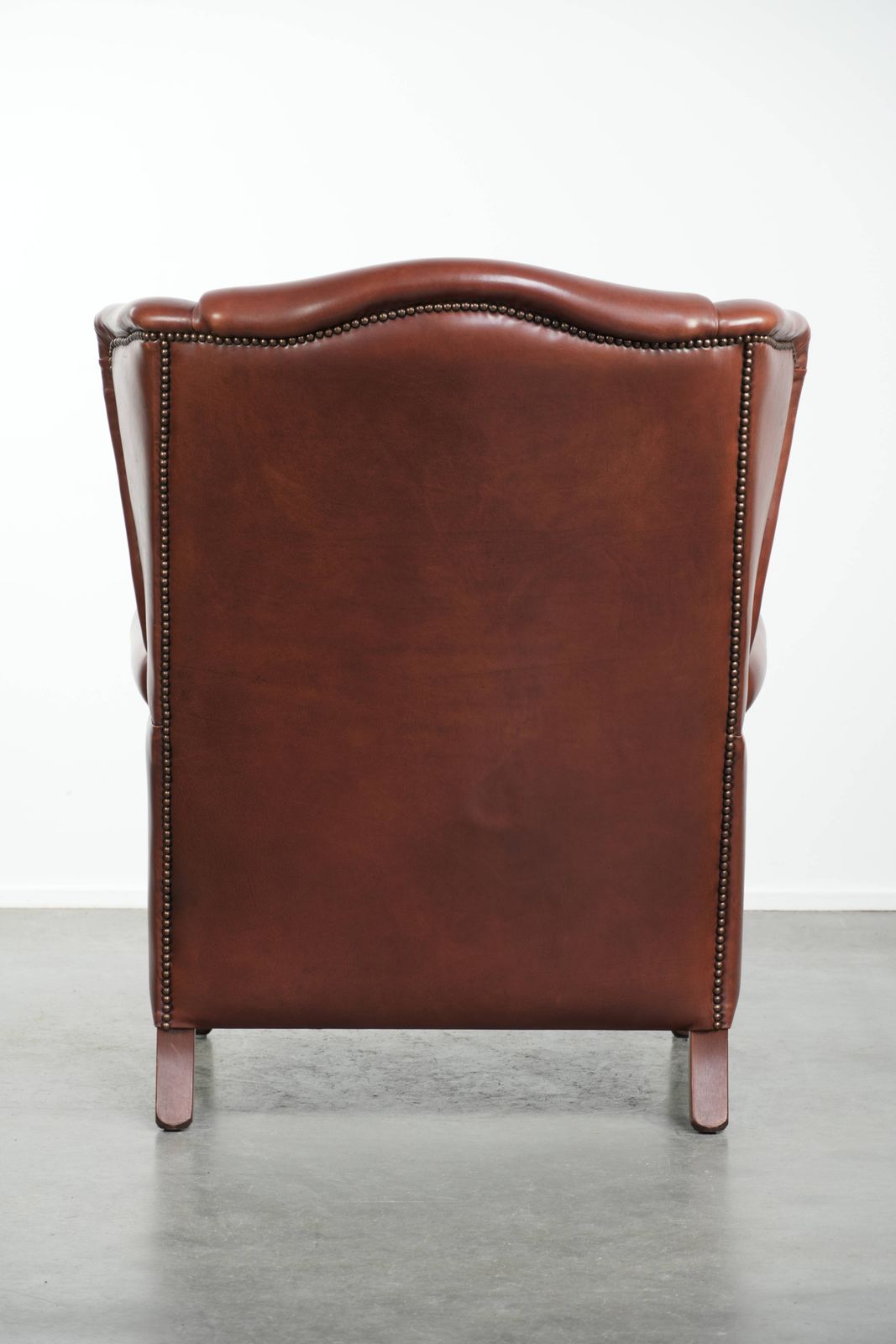 Comfortable Cognac Colored Cowhide Leather Wing Armchair In English Style With A Warm Appearance photo Furniture
