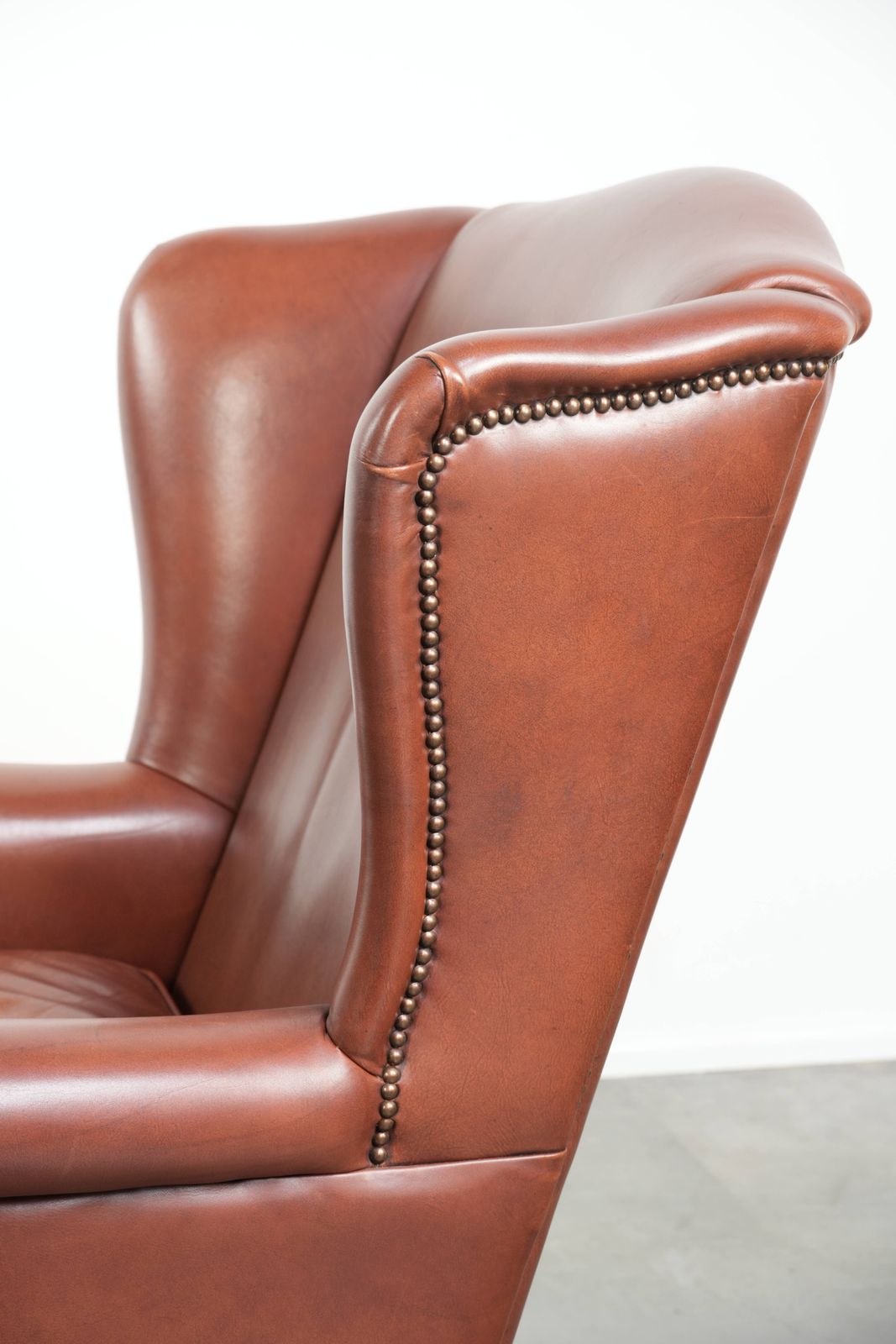 photo vinterior Comfortable Cognac Colored Cowhide Leather Wing Armchair In English Style With A Warm Appearance