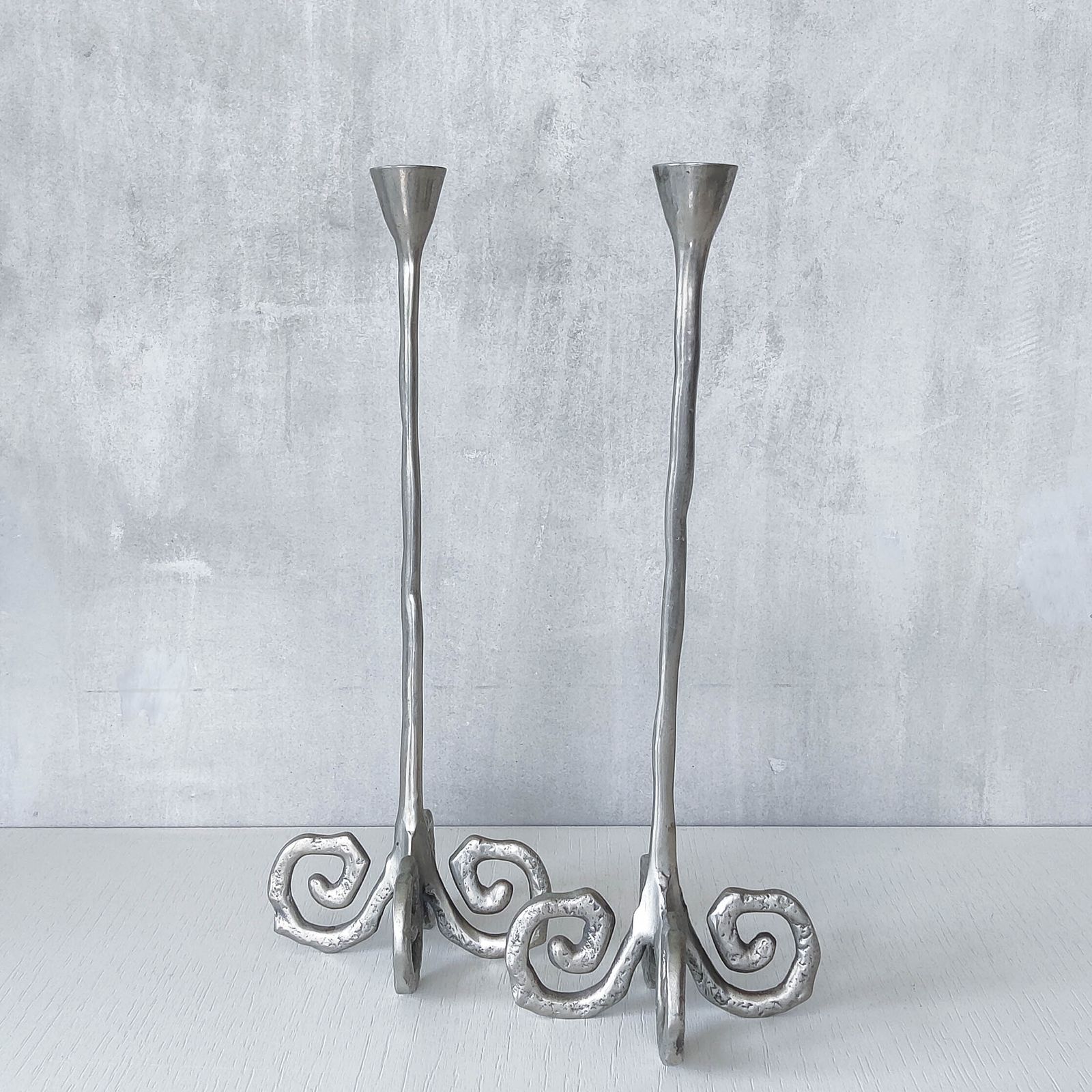 photo vintage Pair Of Vintage Cast Aluminium Candle Holders With Spiral Feet