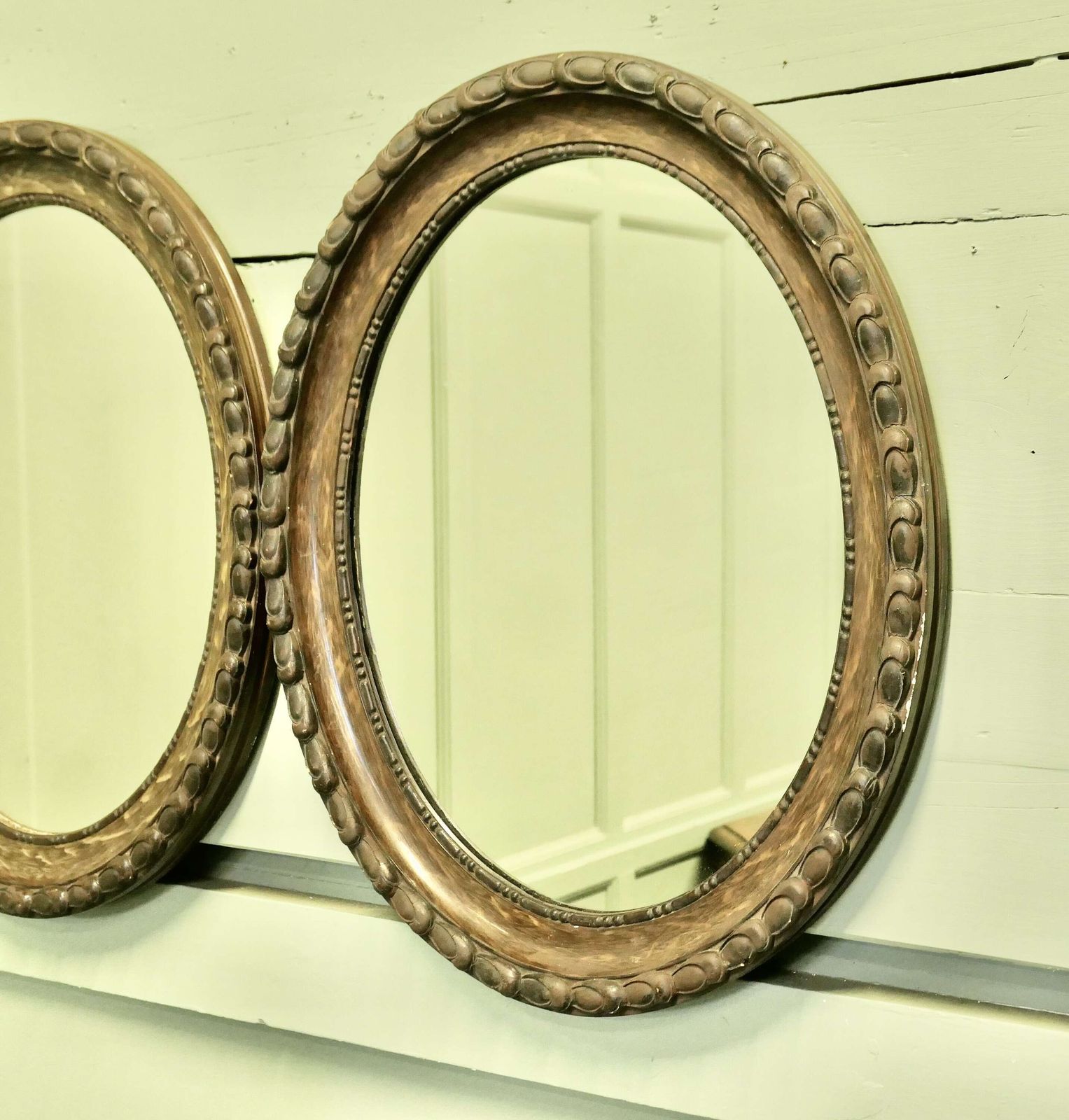 A Pair Of Simulated Wood Finish Oval Mirrors These Mirrors Have Very Attractive Wide Moul photo Home Decor