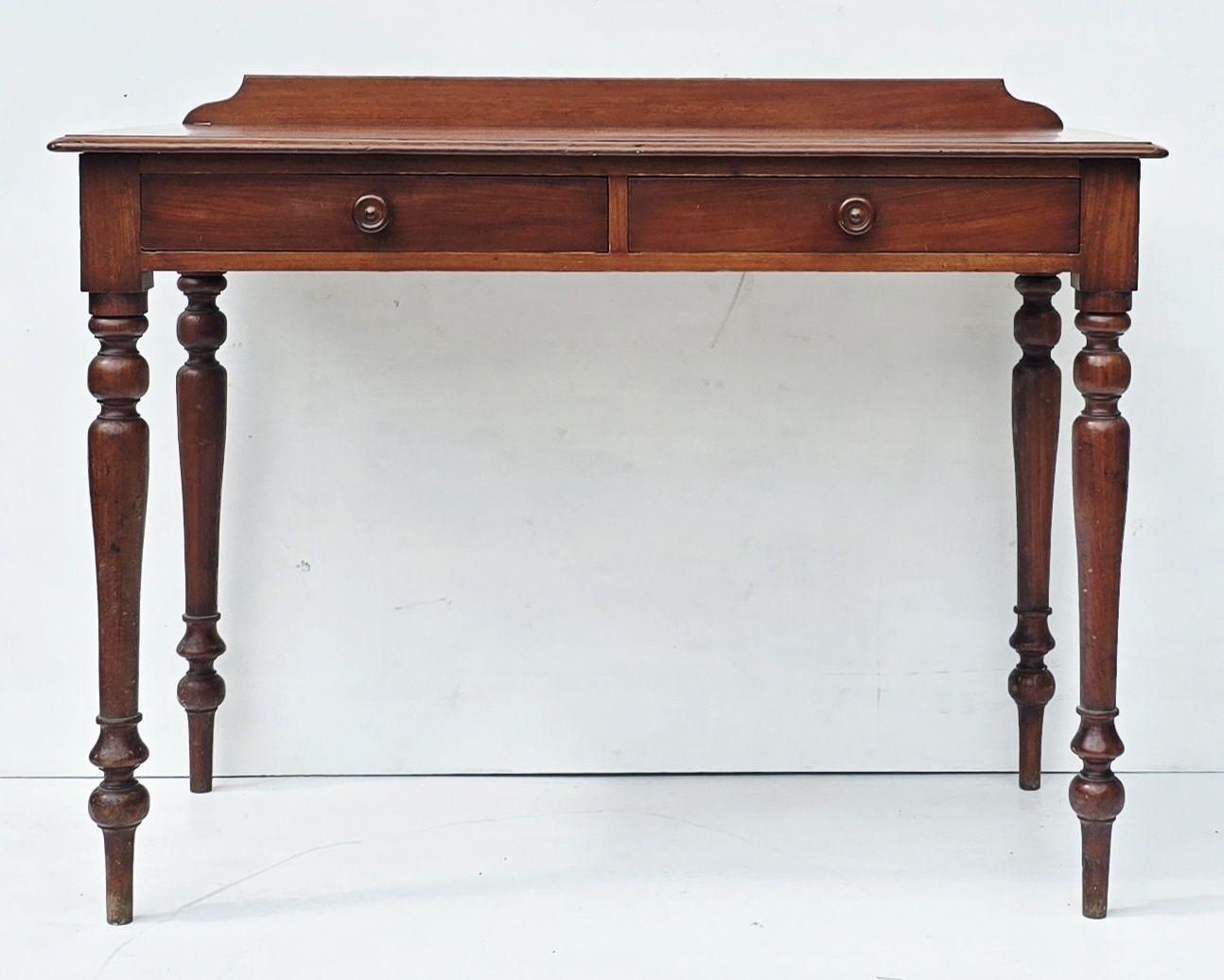 An Antique Mahogany Writing Desk On Turned Legs, 19th C.