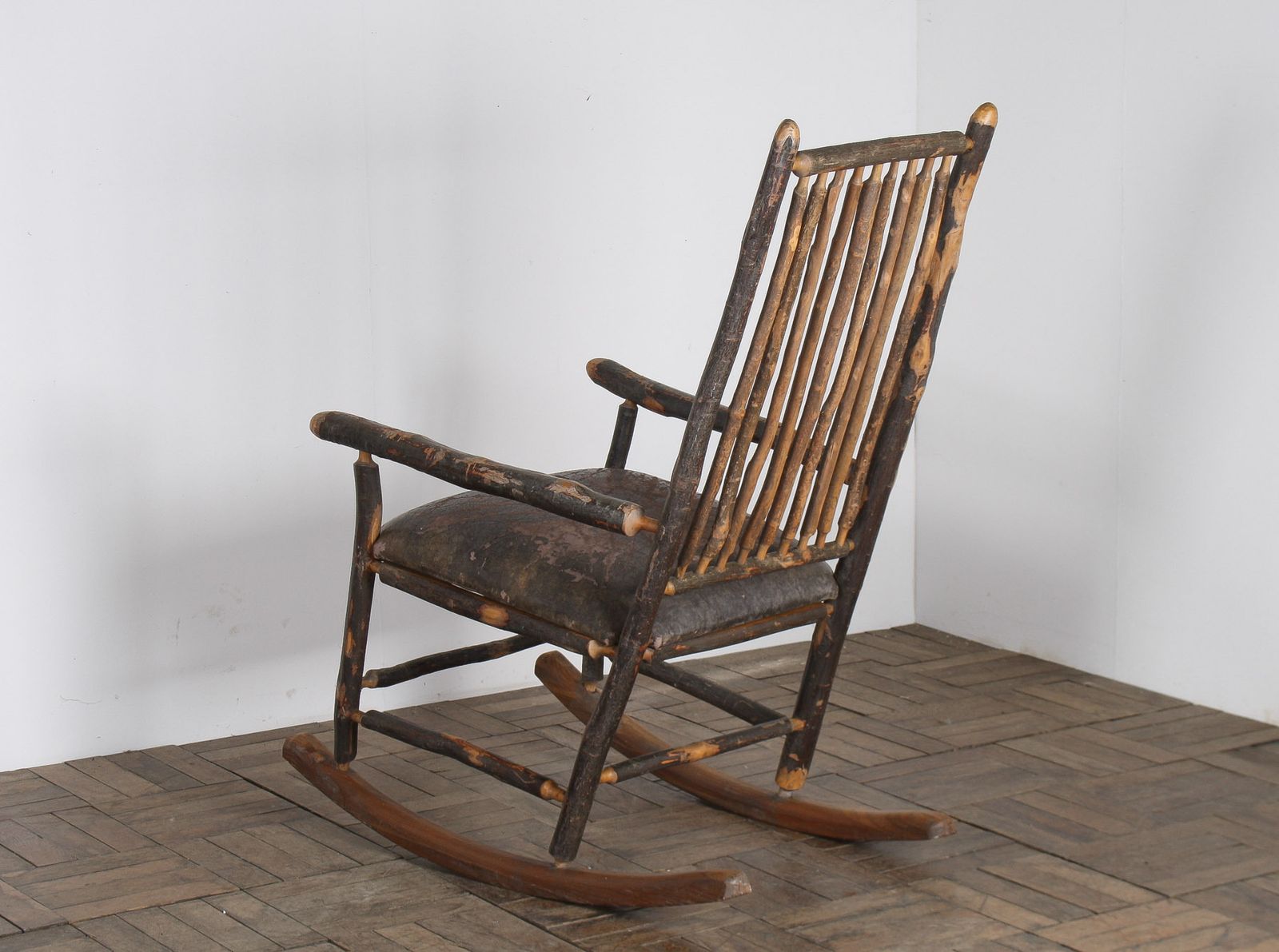 Furniture Antique American Stick Back Rocking Chair With Distressed Patina And Leather Seat photo
