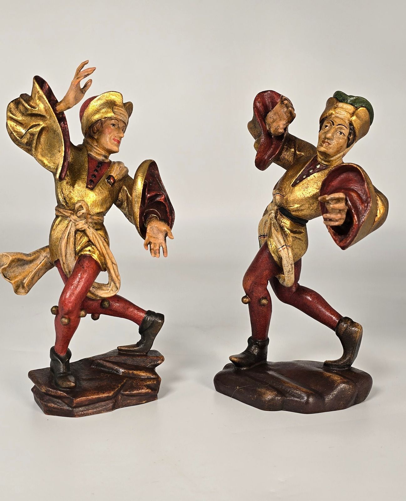 A Pair Of Swiss Or Black Forest Carved And Polychrome And Gilt Painted Jester Figures Circa 1930