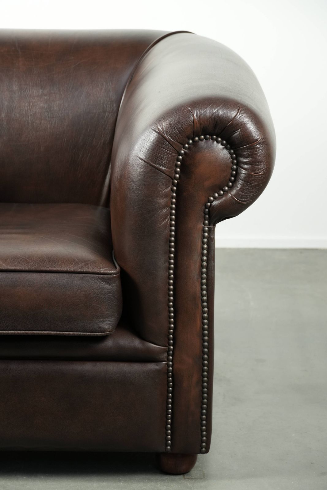 photo furniture Luxurious Brown Cowhide Chesterfield Armchair With A Timeless English Look.