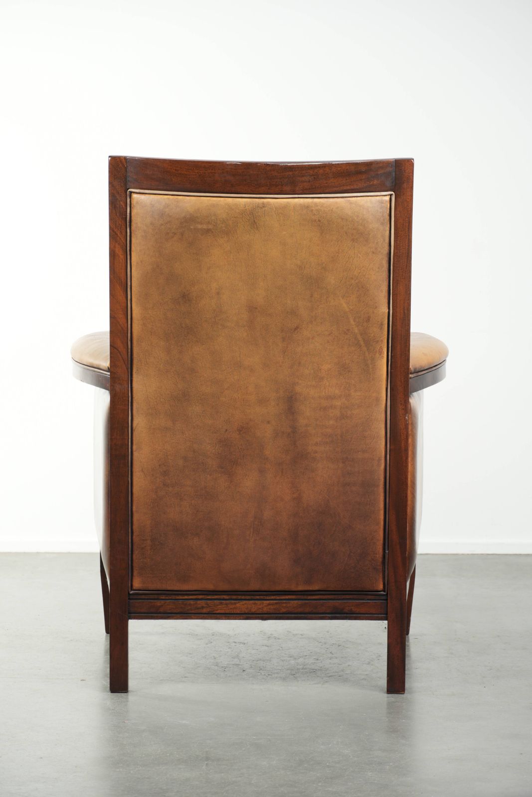 Comfortable Cognac Colored Art Deco Design Armchair Made Of Sheepskin Combined With Wood, With A High Back. photo Furniture