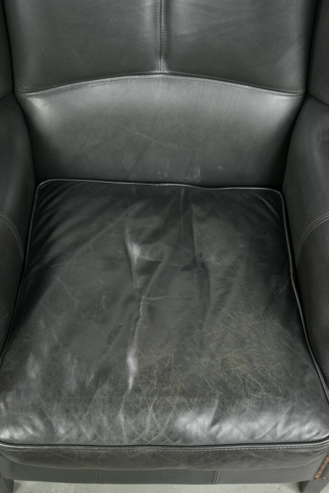 Black Cowhide Wing Armchair In A Classic English Style, Finished With Decorative Nails. photo vinterior