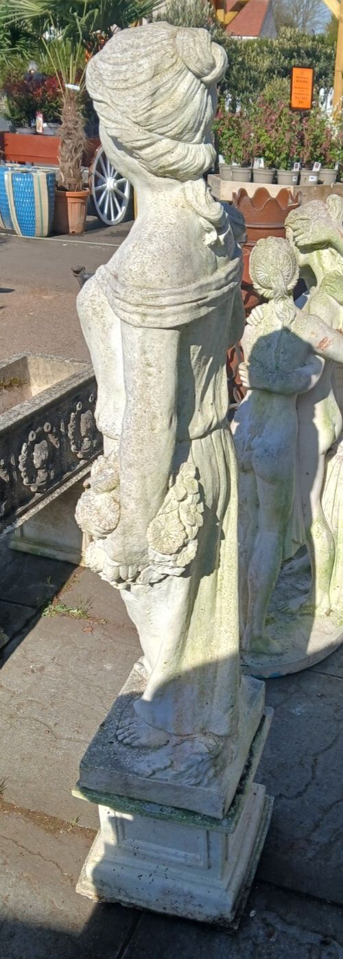 Weathered Concrete Statue Of Female Carrying Flowers photo Art