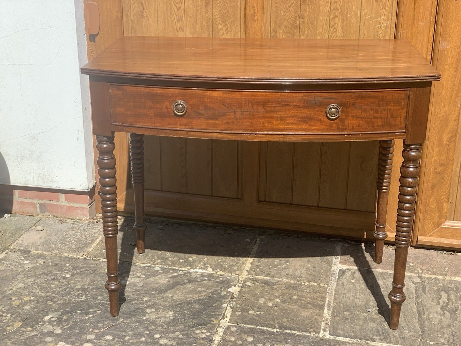A Regency Bowfront Side Table With Bobbin Legs. photo furniture
