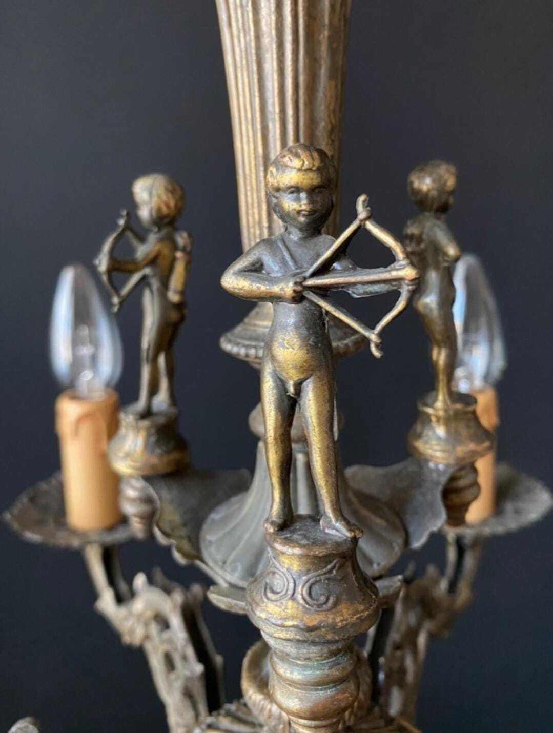 photo for sale Lustre d'époque en laiton aux archers