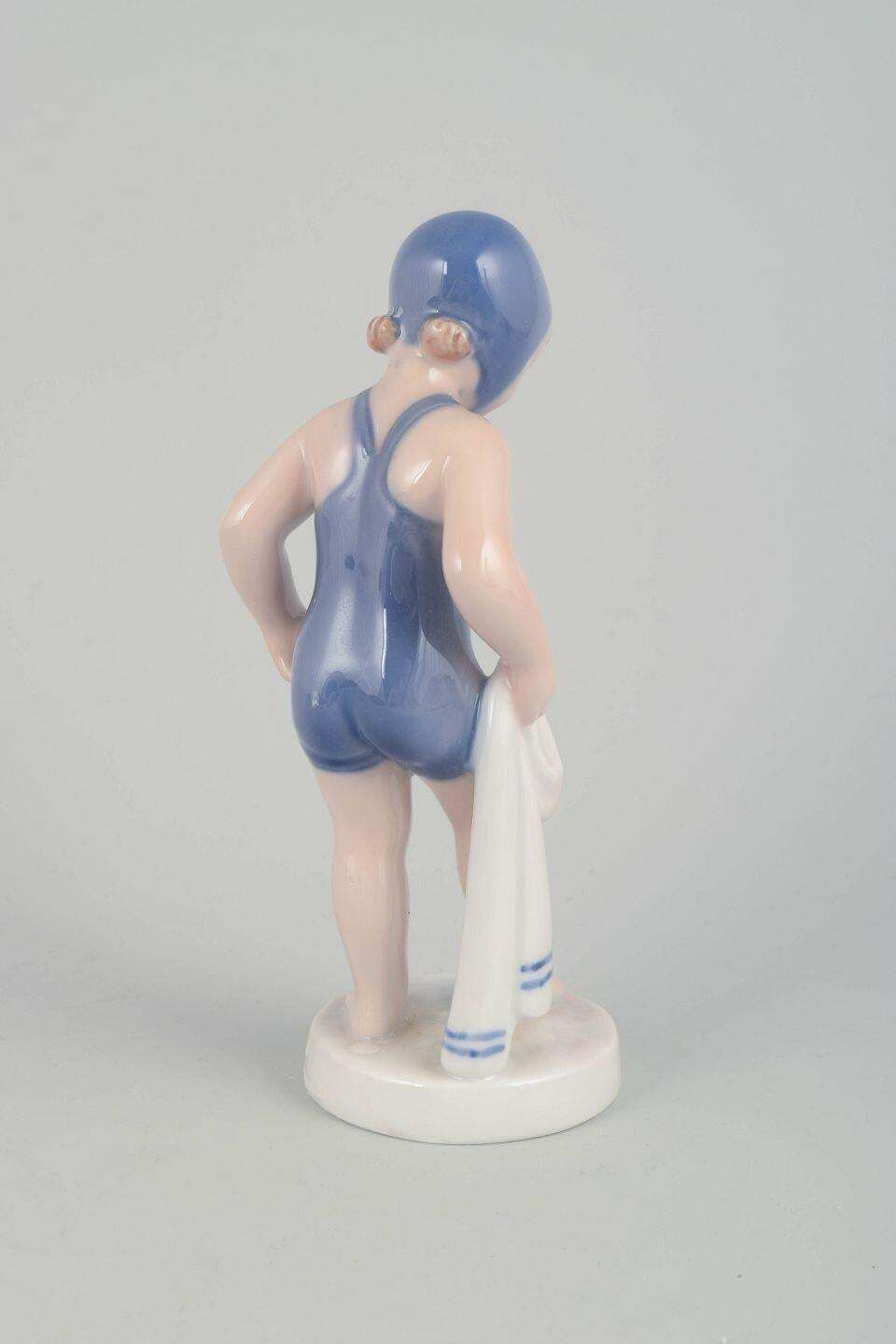 Royal Copenhagen. "The Swimmer" Porseleinen Beeldje Van Meisje In Blauwe Badpak. photo for sale