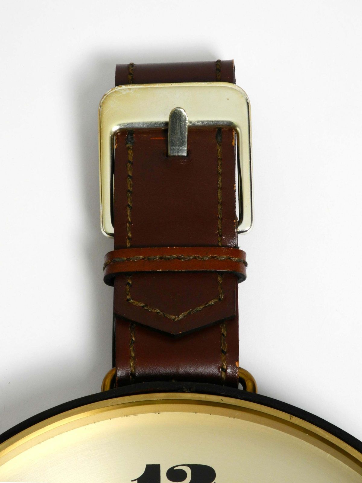 photo for sale Junghans Messing Wandklok uit de jaren 1960 met Lederen Ophangband