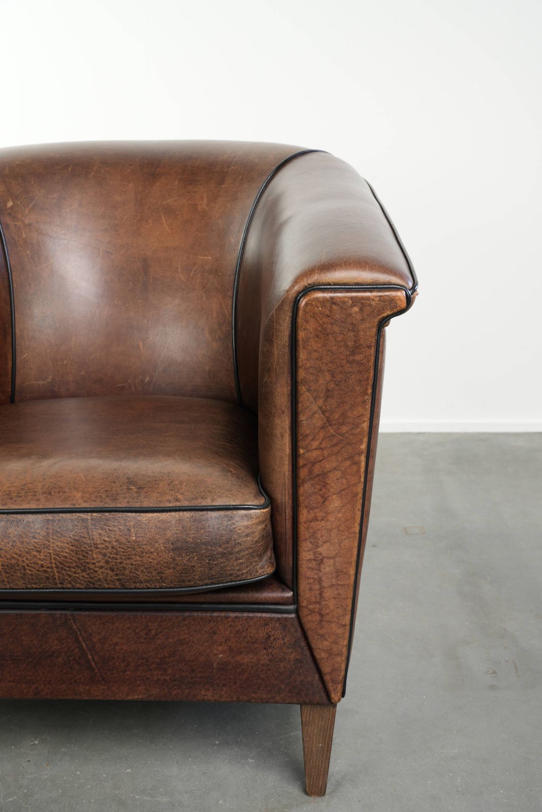 photo furniture Nice And Sleek Art Deco Designed Sheepskin Club Armchair Finished With Black Piping
