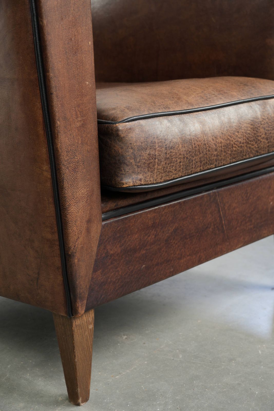 Meubels Strakke art deco schapenvacht club fauteuil met zwarte biesafwerking photo