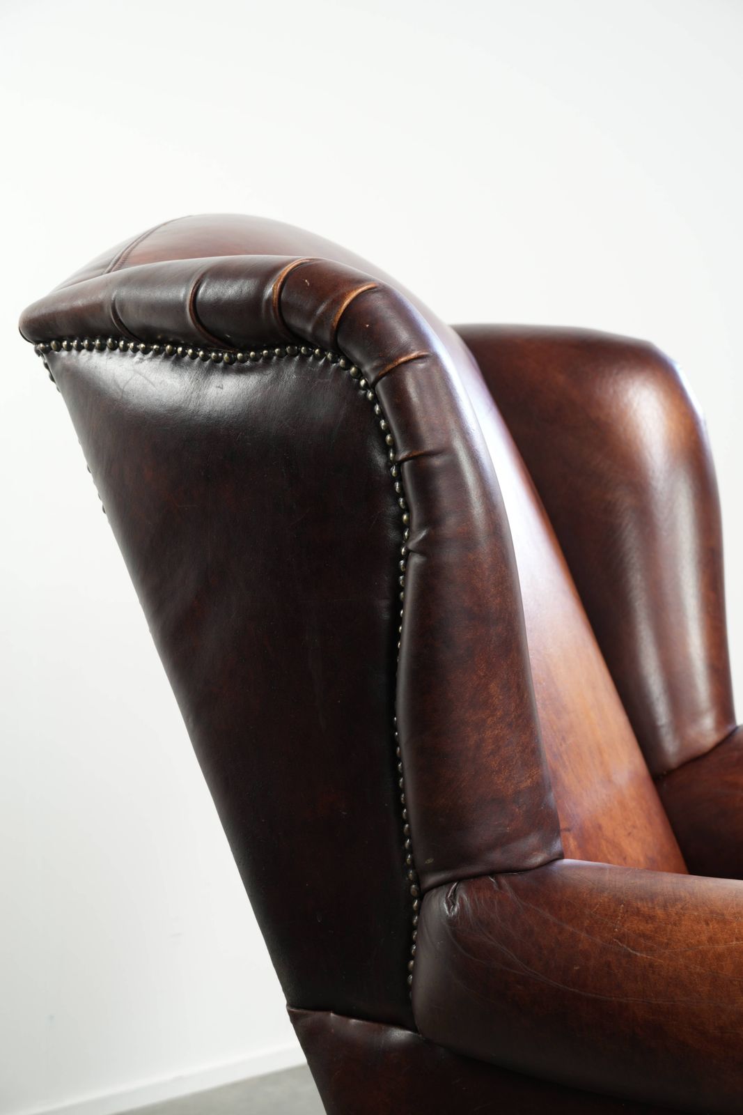 photo for sale Comfortable English Style Cowhide Wing Armchair With A Beautiful Warm Color Scheme And A Characterful Appearance.