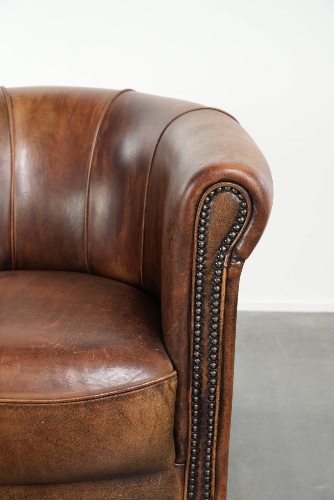 photo furniture Sturdy And Characterful Sheepskin Club Armchair With A Beautiful Patina, Finished With Decorative Nails.