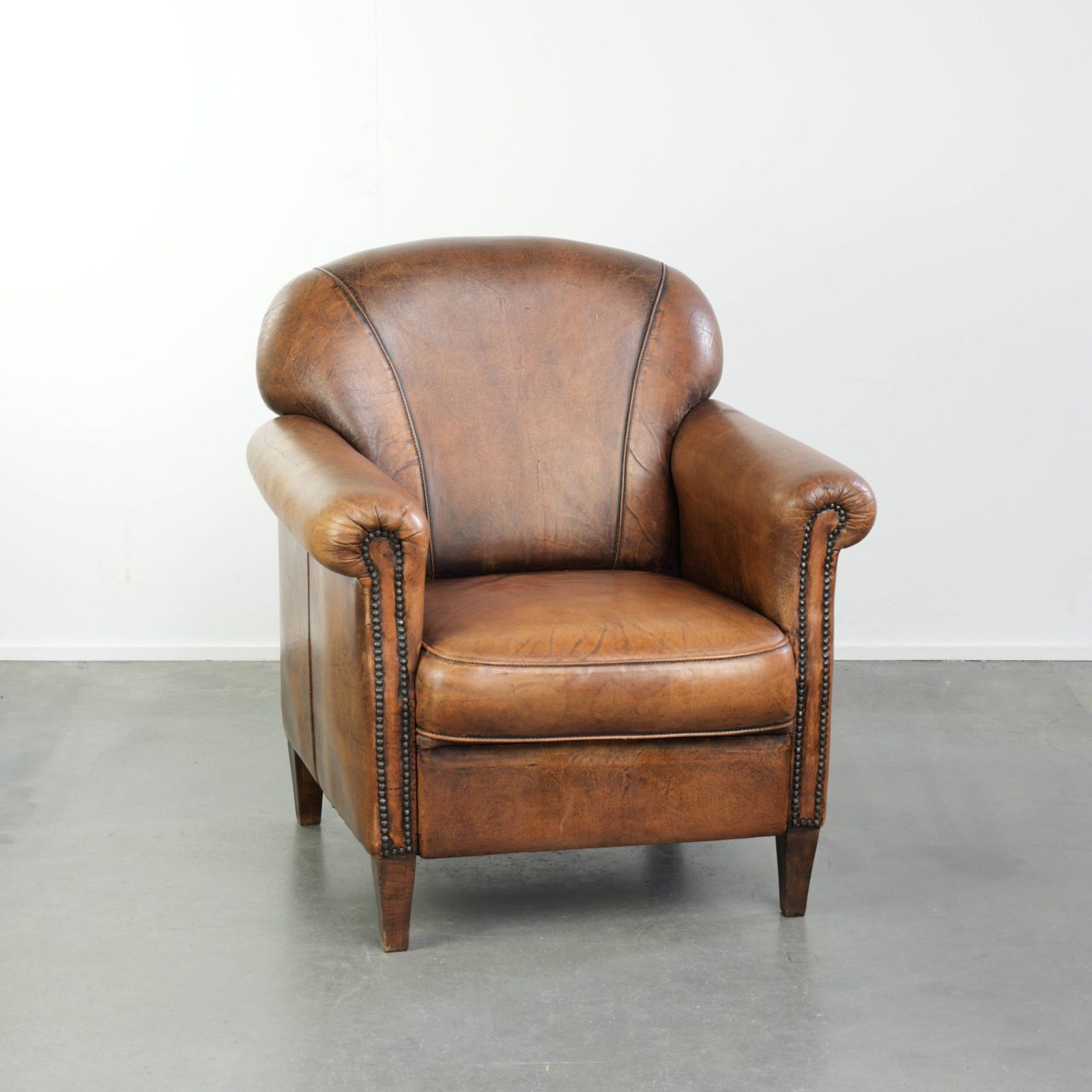 Comfortable, Characterful Sheepskin Armchair Finished With Decorative Nails And A Beautiful Patina