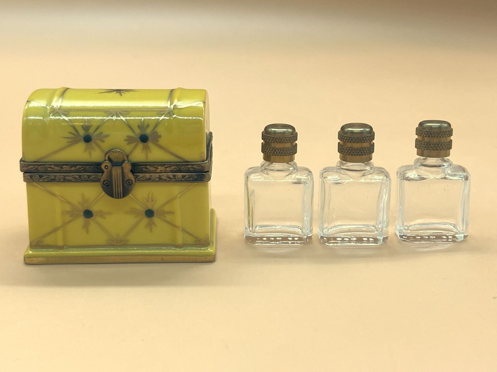 Limoges Porcelain France gele kistjesvorm snuisterdoosje met 3 glazen parfumflesjes.