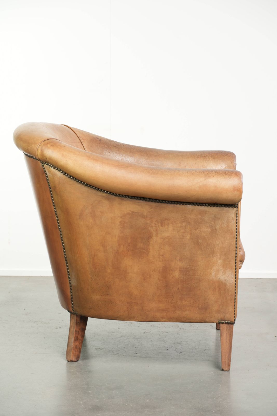 Characterful Sheepskin Club Armchair In A Light Cognac Color, Finished With Decorative Nails. photo for sale
