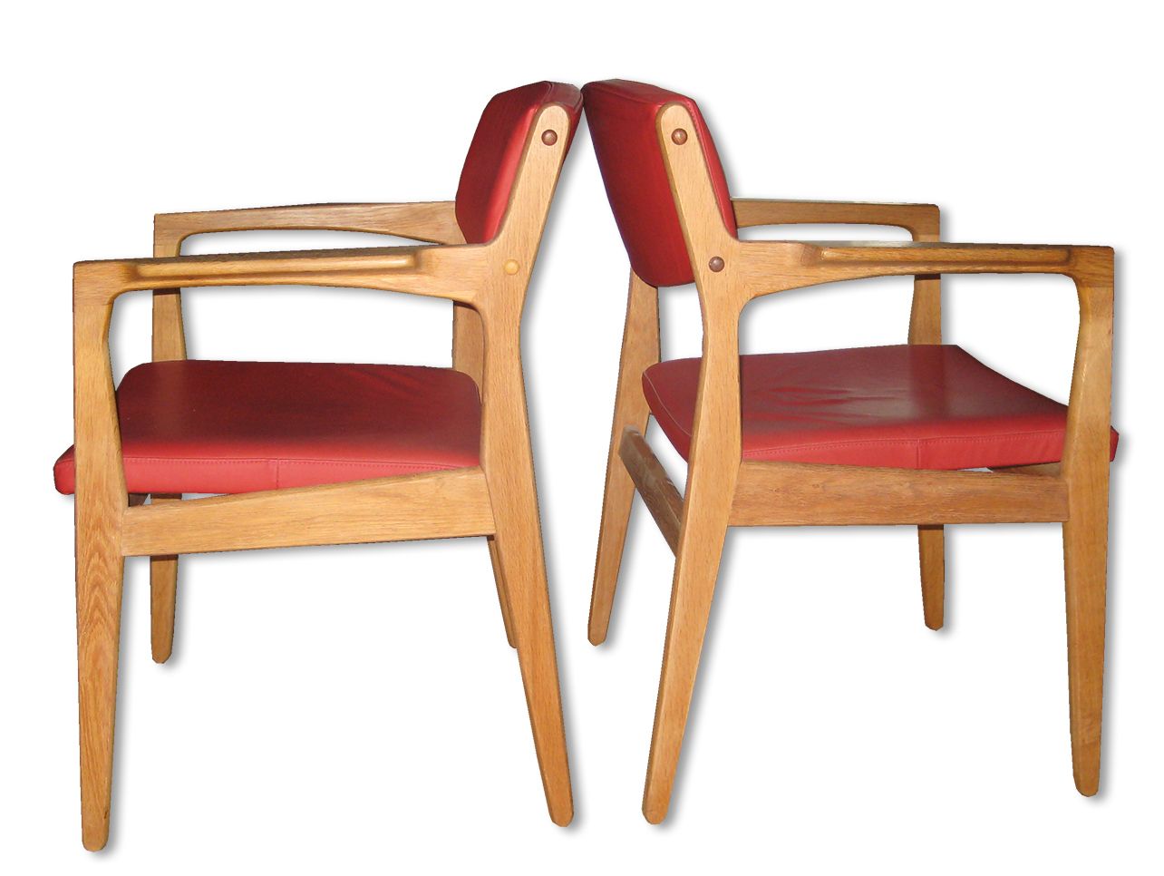 A Pair Of Armchairs Of Oak Upholstered In Red Leather
