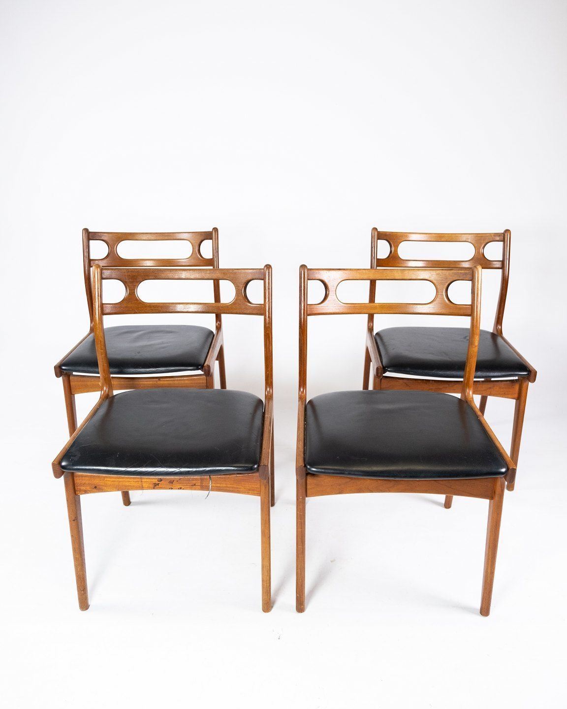 A Set Of Four Dining Chairs In Teak And Upholstered With Black Leather Of Danish Design From The 1960s. photo furniture