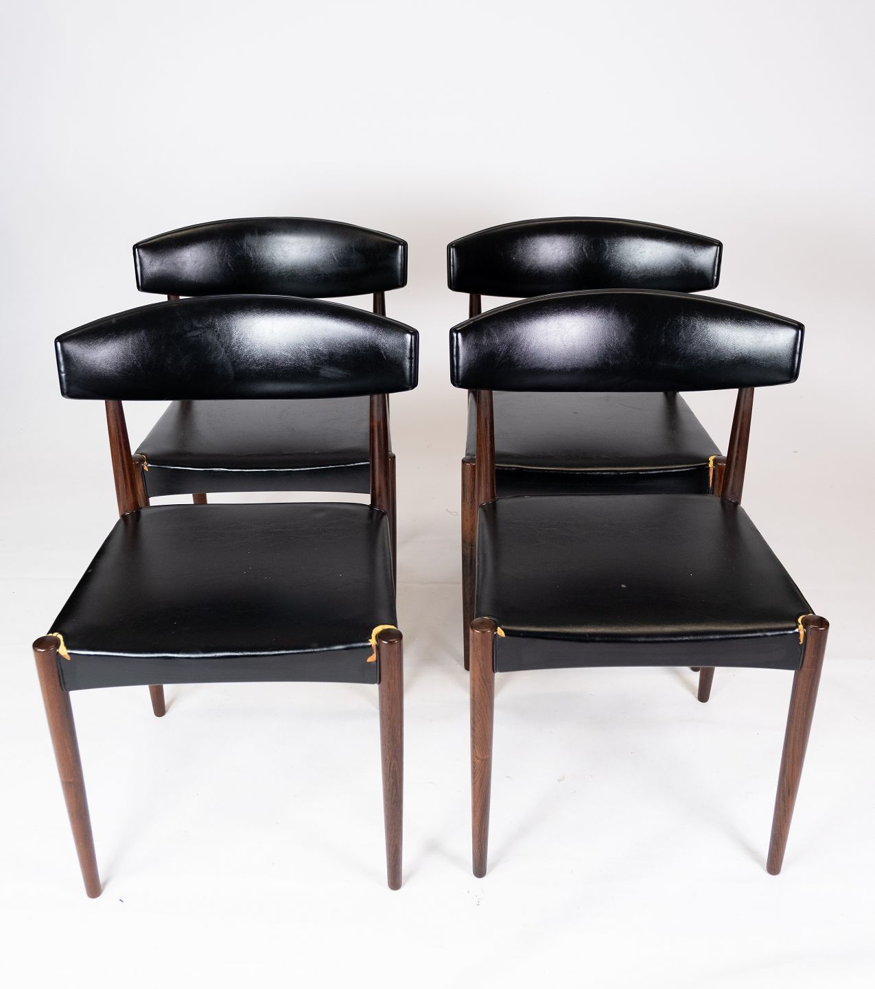 Set Of Four Dining Chairs In Rosewood And Black Leather Of Danish Design From The 1960s.