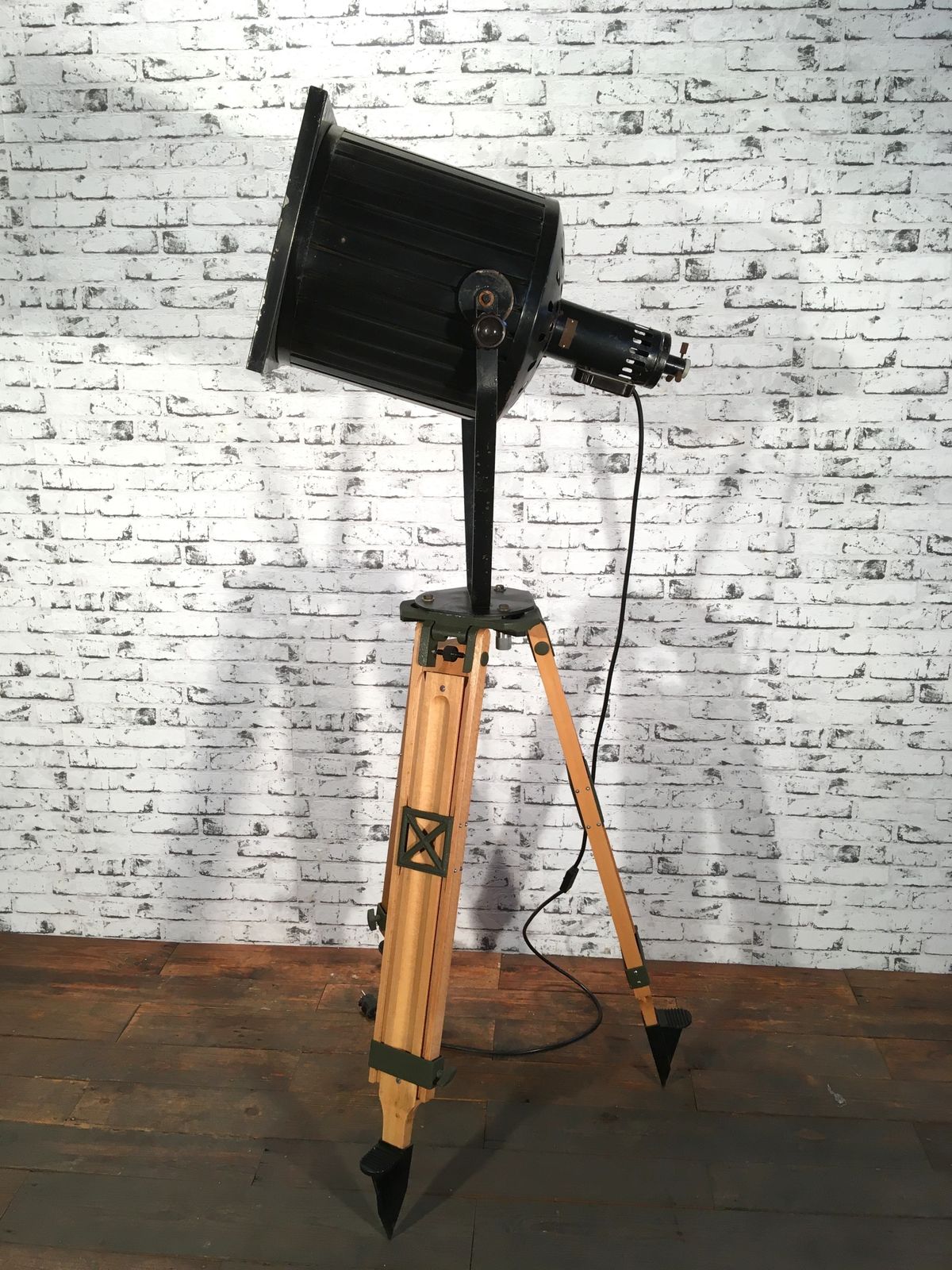 Black Vintage Industrial Spotlight On Wooden Tripod  photo vinterior